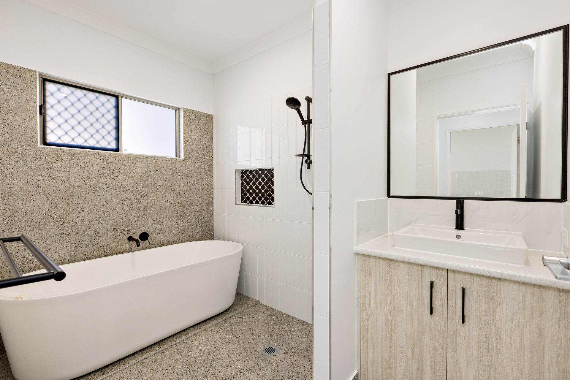 Modern Bathroom With a Freestanding White Tub — Ashlee Jones Homes in Gordonvale, QLD