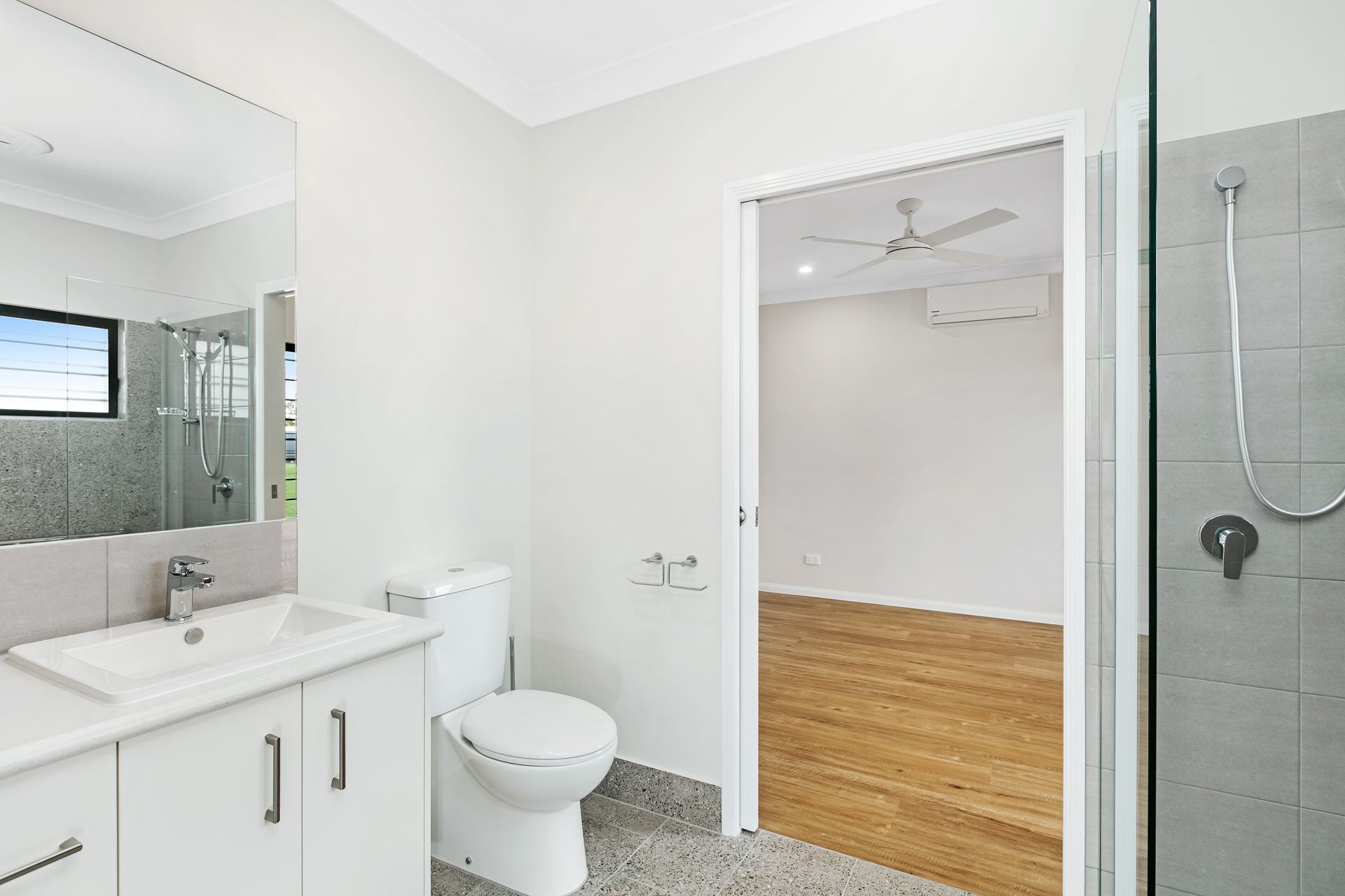 A Bright, Modern Bathroom With a White Vanity — Ashlee Jones Homes in Gordonvale, QLD