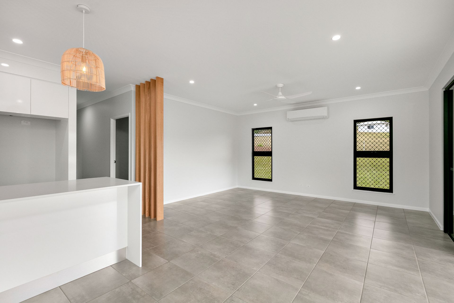 A Modern, Minimalist Open-plan Room With White Walls — Ashlee Jones Homes in Gordonvale, QLD