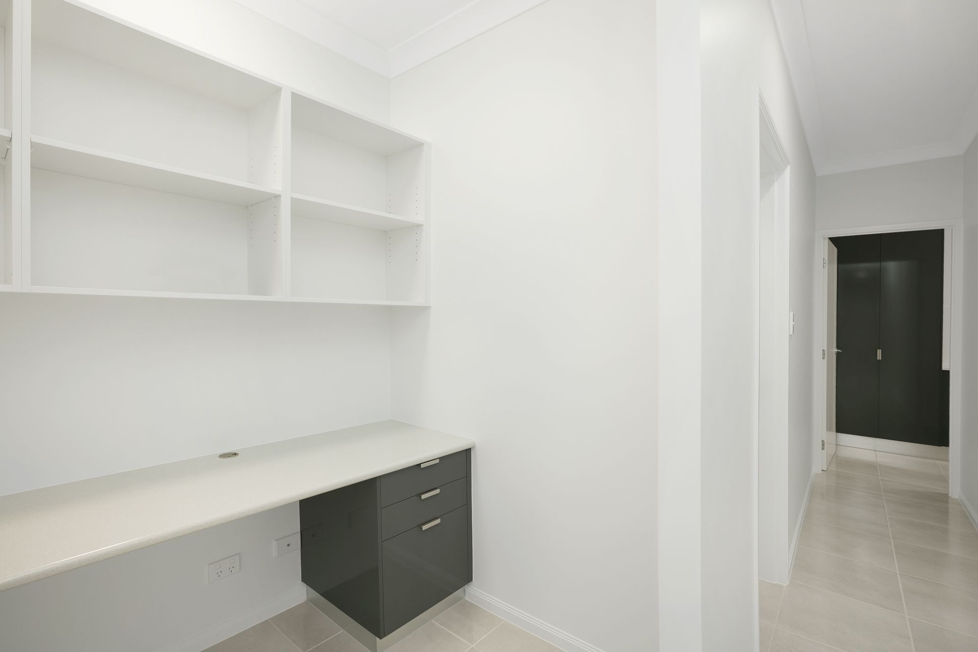 A Modern Home Office Nook With White Walls, Built-in Shelving — Ashlee Jones Homes in Gordonvale, QLD