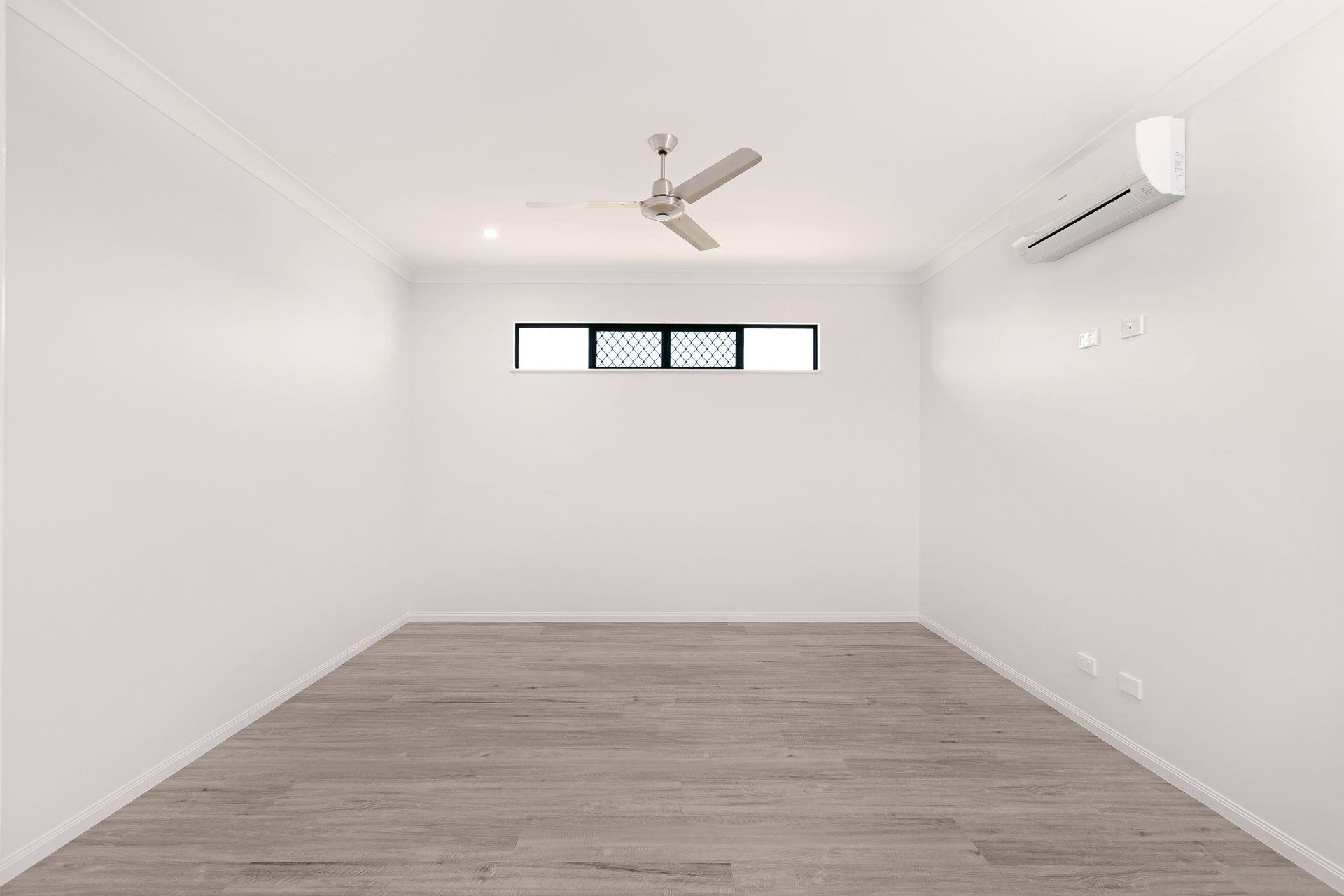A Minimalist, Empty Room With Plain White Walls — Ashlee Jones Homes in Gordonvale, QLD