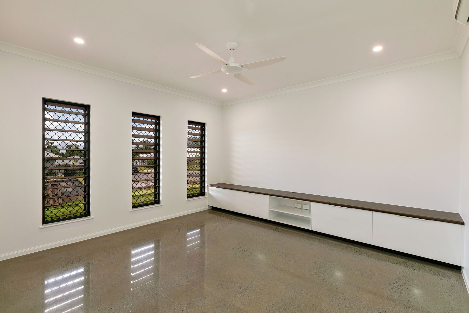 Empty Room With Three Windows, a White Media Console — Ashlee Jones Homes in Gordonvale, QLD