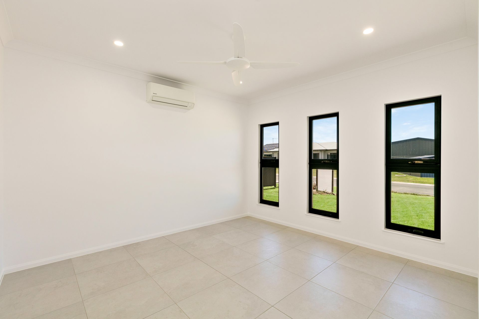 An Empty Room With White Walls, Light-colored Floor Tiles — Ashlee Jones Homes in Gordonvale, QLD