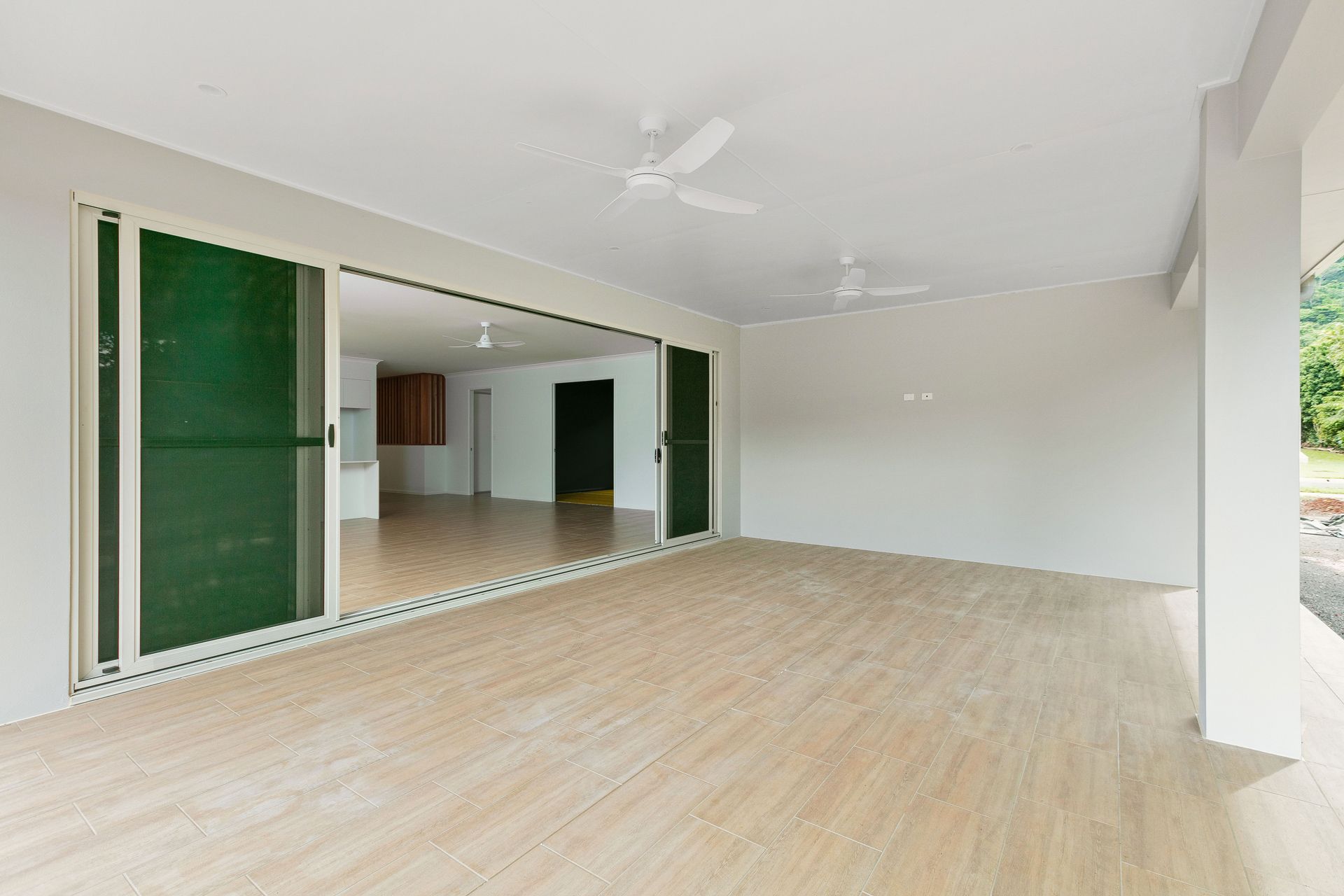 A Spacious, Tiled Patio Area Opening Into a Bright — Ashlee Jones Homes in Gordonvale, QLD