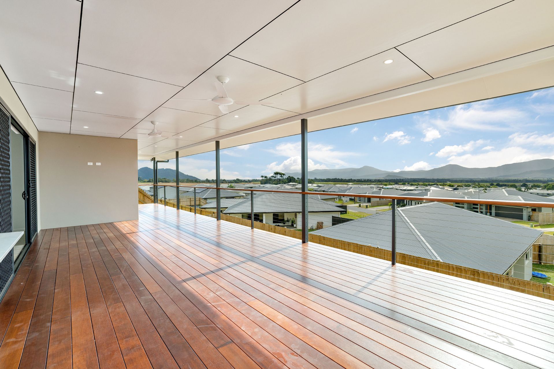 A Wooden Balcony With a Modern Railing — Ashlee Jones Homes in Gordonvale, QLD