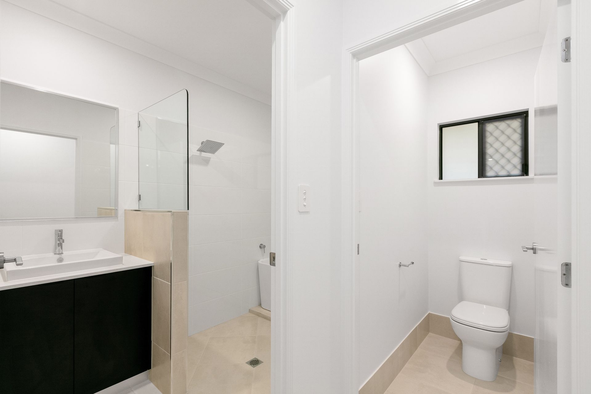 A Modern, Clean Bathroom With a Vanity, Walk-in Shower — Ashlee Jones Homes in Gordonvale, QLD