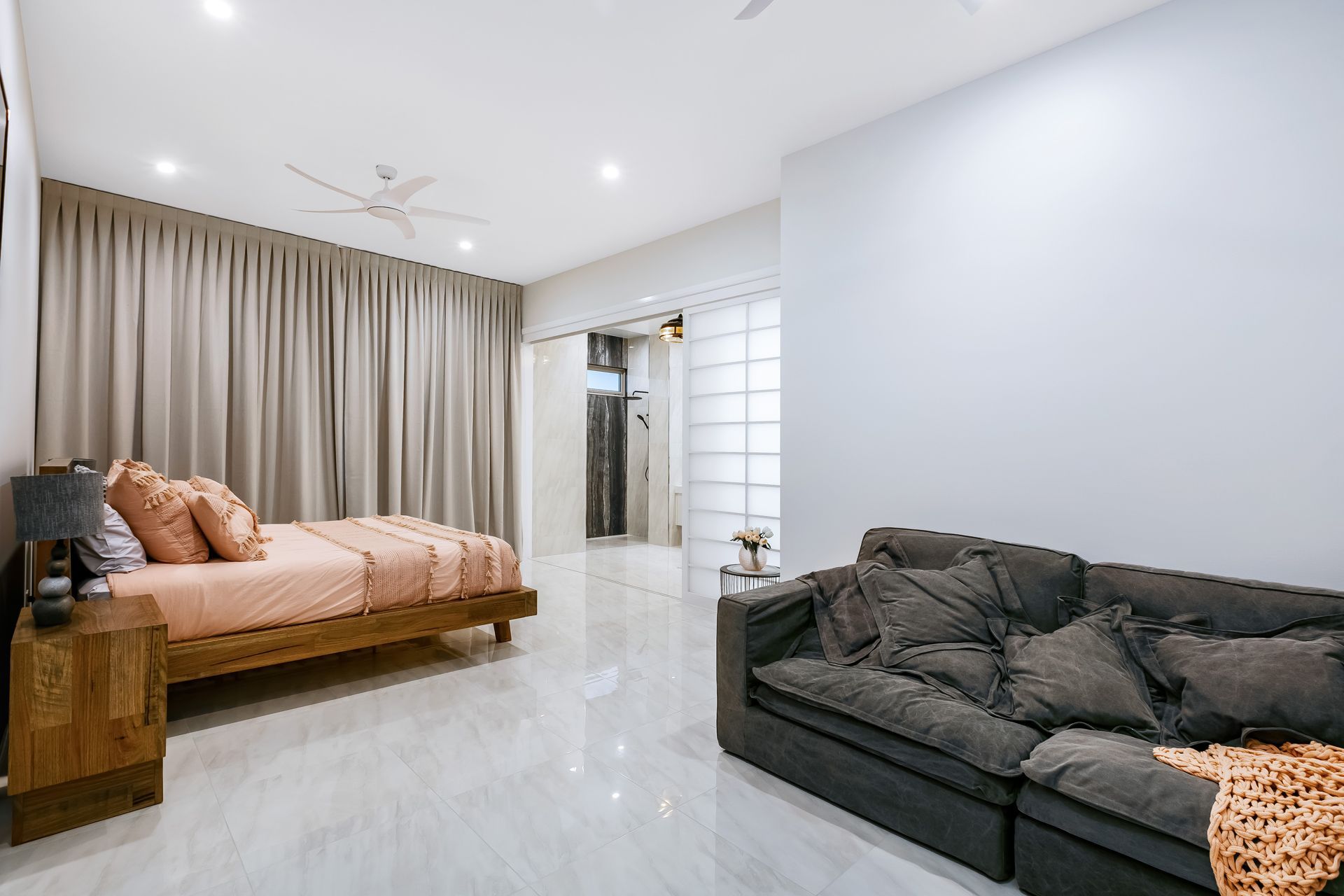 A Modern Bedroom With a Bed Featuring Peach Bedding — Ashlee Jones Homes in Gordonvale, QLD