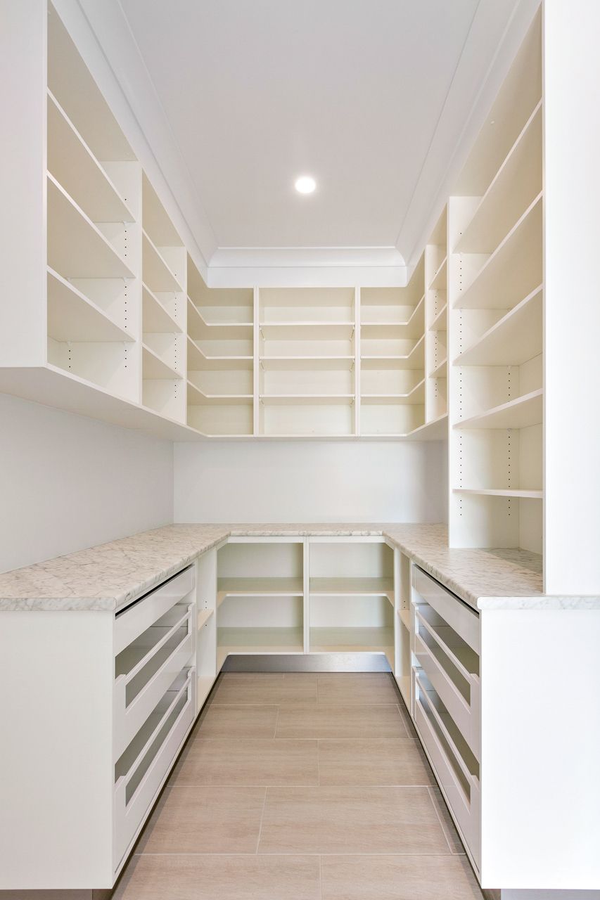 A Walk-in Pantry Featuring White Shelving, Light Countertops — Ashlee Jones Homes in Gordonvale, QLD