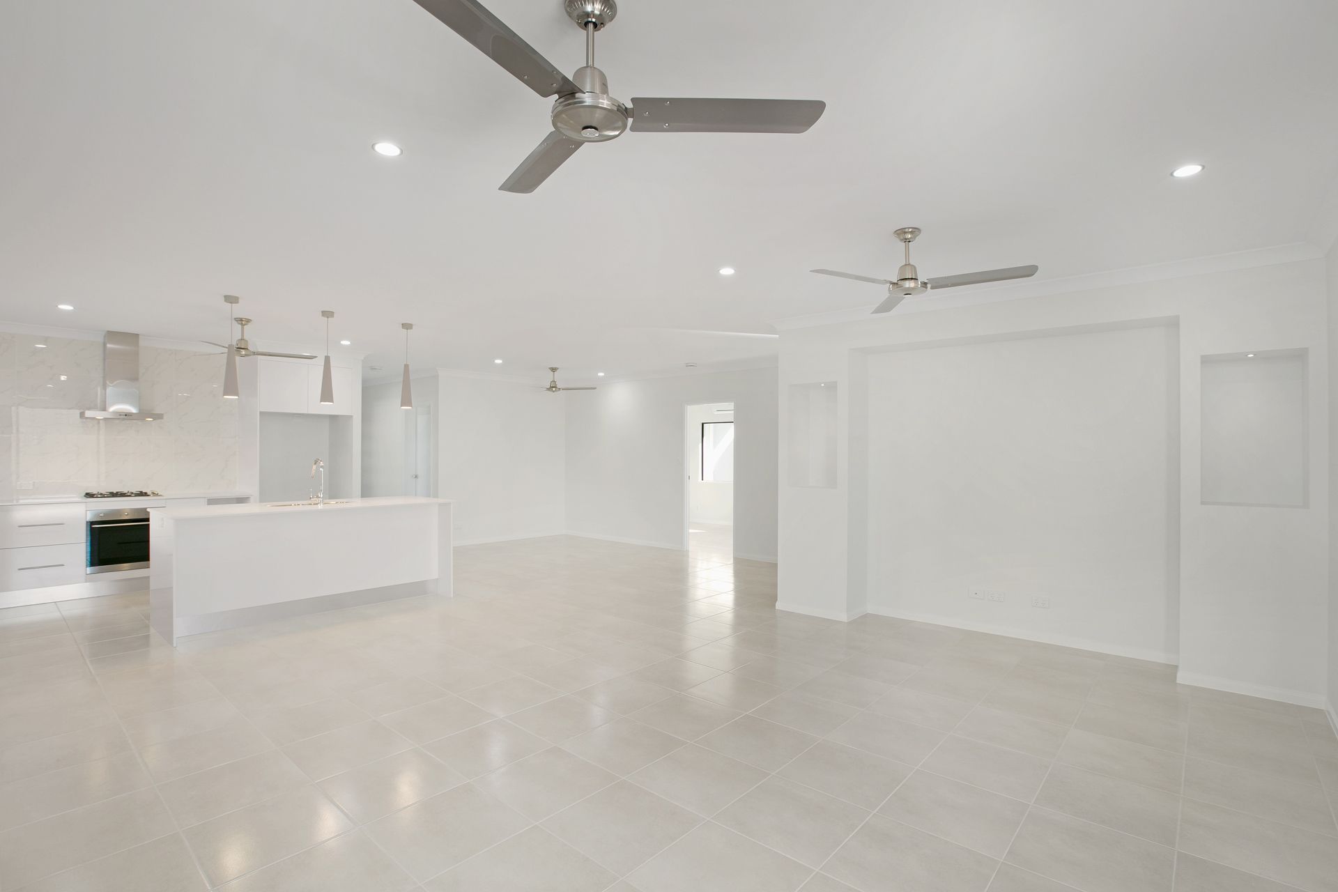 A Spacious, Modern Open-plan Room With White Walls — Ashlee Jones Homes in Gordonvale, QLD