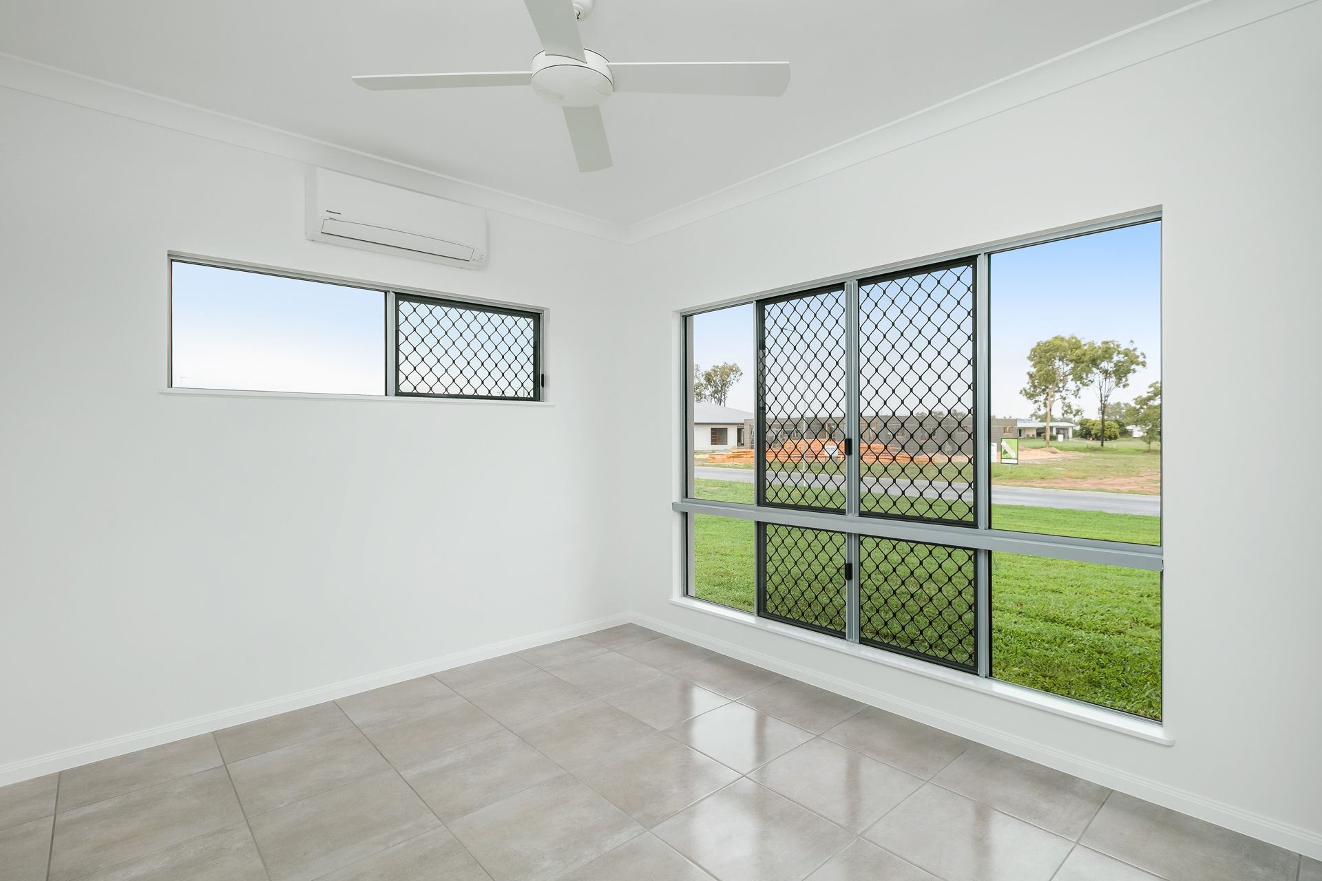 An Empty Room With White Walls, Tiled Floors — Ashlee Jones Homes in Gordonvale, QLD