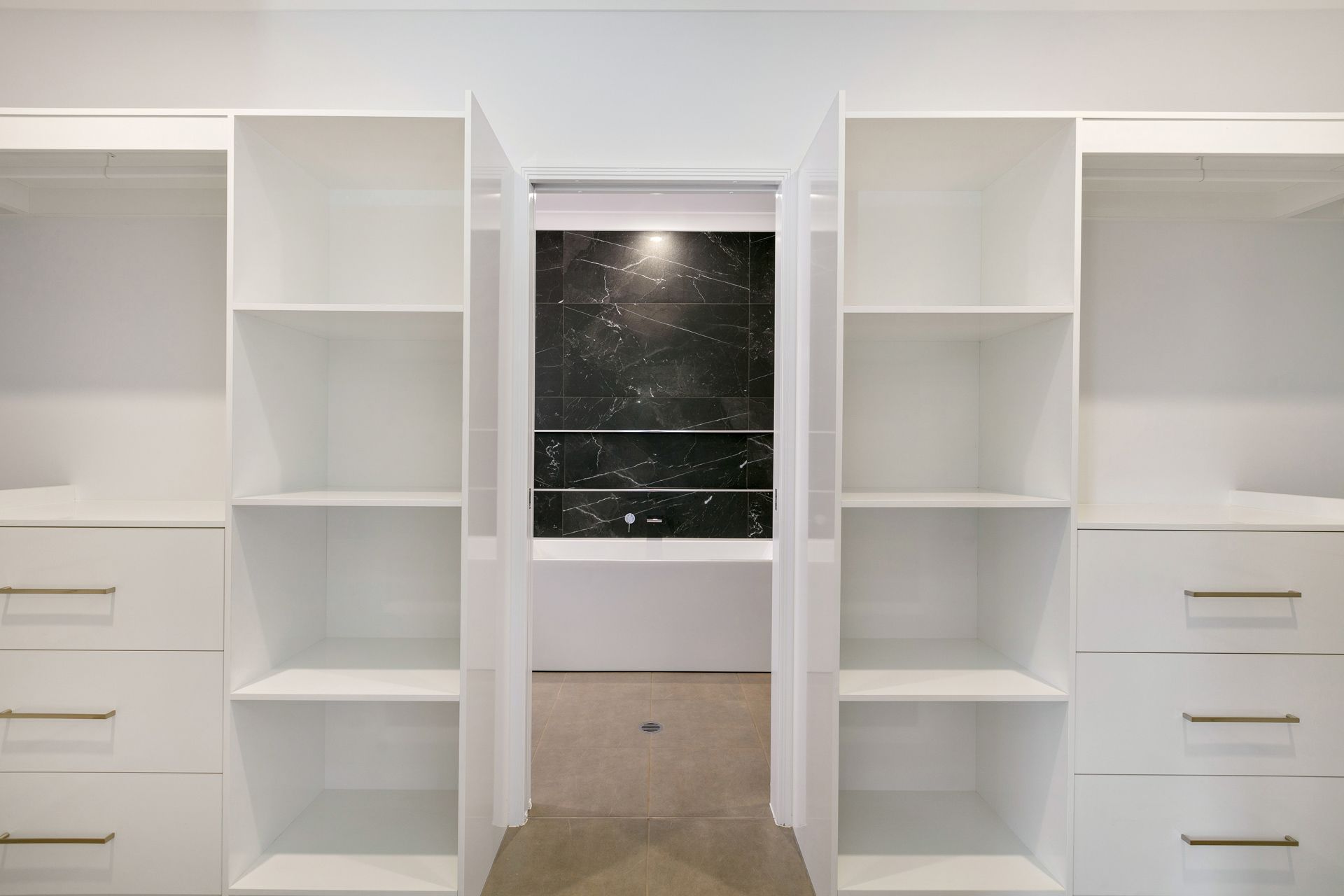 White Built-in Closet Shelving and Drawers Flanking — Ashlee Jones Homes in Gordonvale, QLD