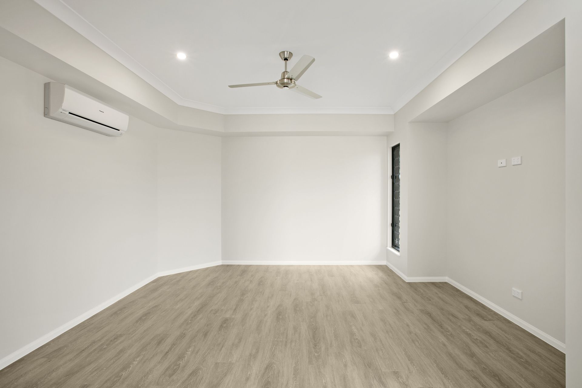 An Empty, Minimalist Room With Light Gray Walls — Ashlee Jones Homes in Gordonvale, QLD
