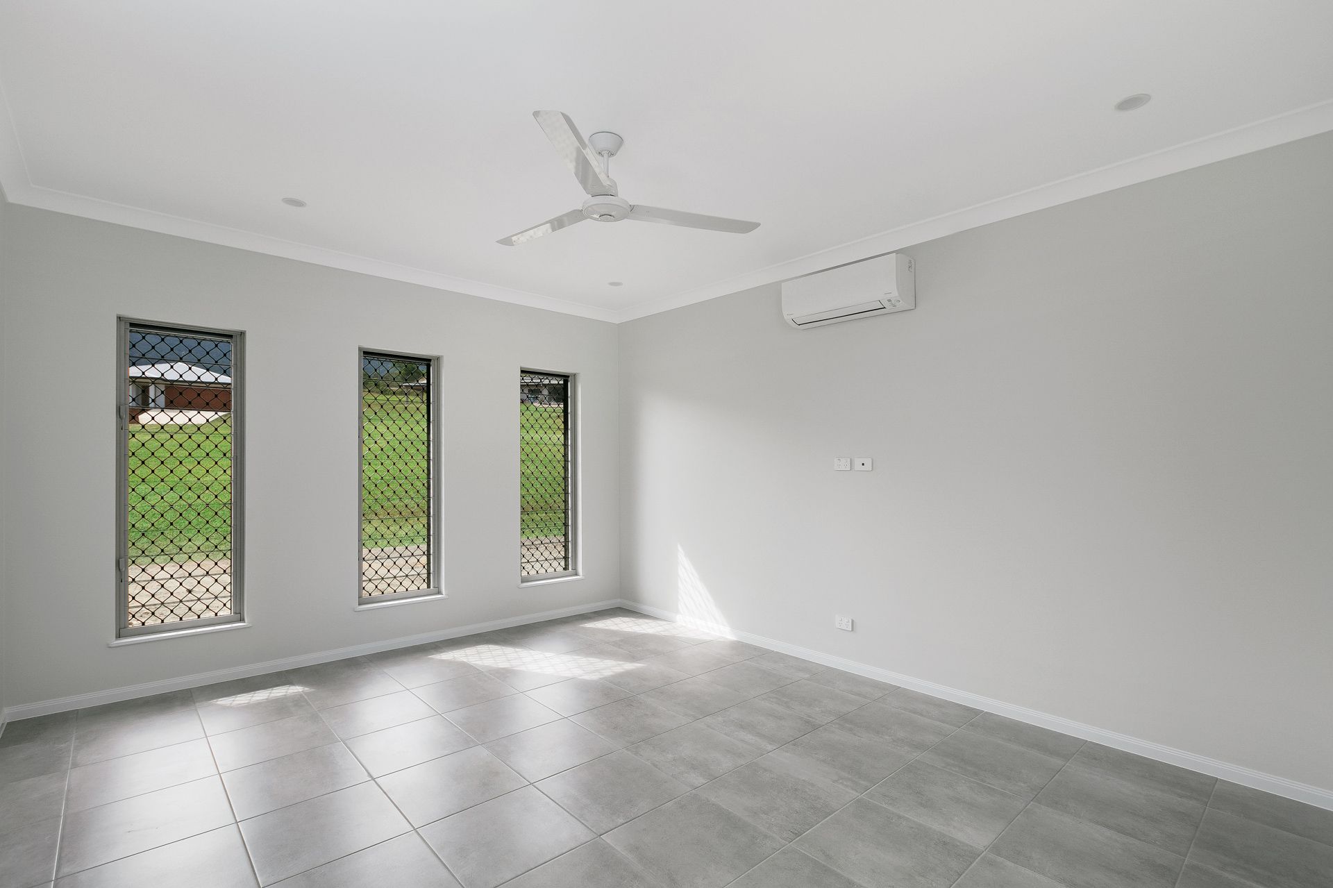 An Empty, Modern Room With Light Grey Walls — Ashlee Jones Homes in Gordonvale, QLD