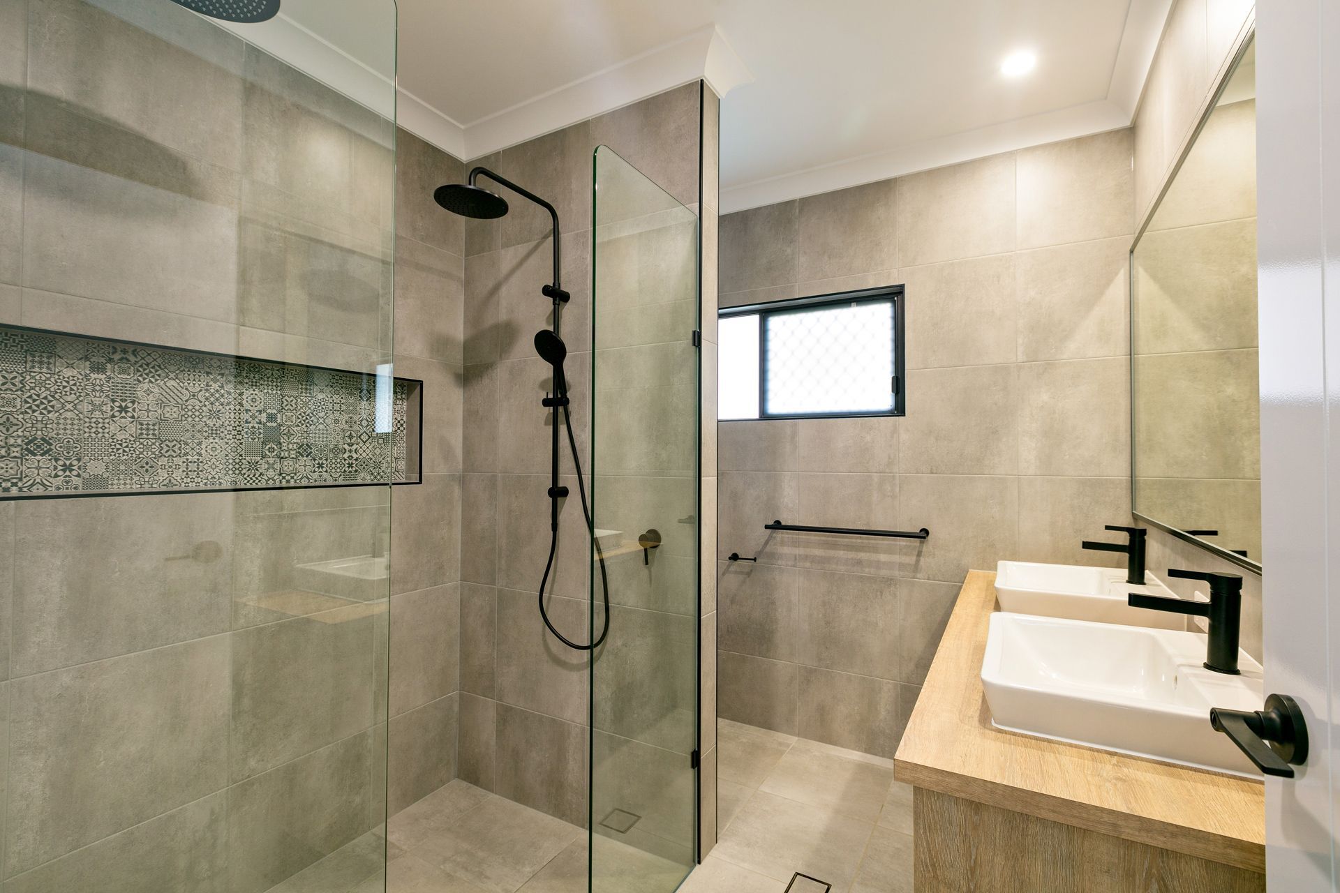 A Modern Bathroom With a Glass-enclosed Shower — Ashlee Jones Homes in Gordonvale, QLD