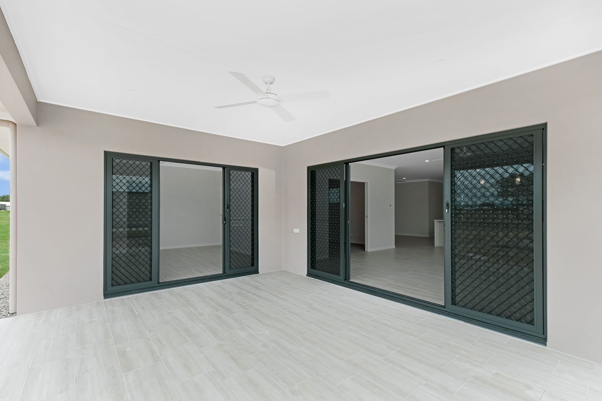 A Covered Outdoor Patio With Light Wood-look Flooring — Ashlee Jones Homes in Gordonvale, QLD