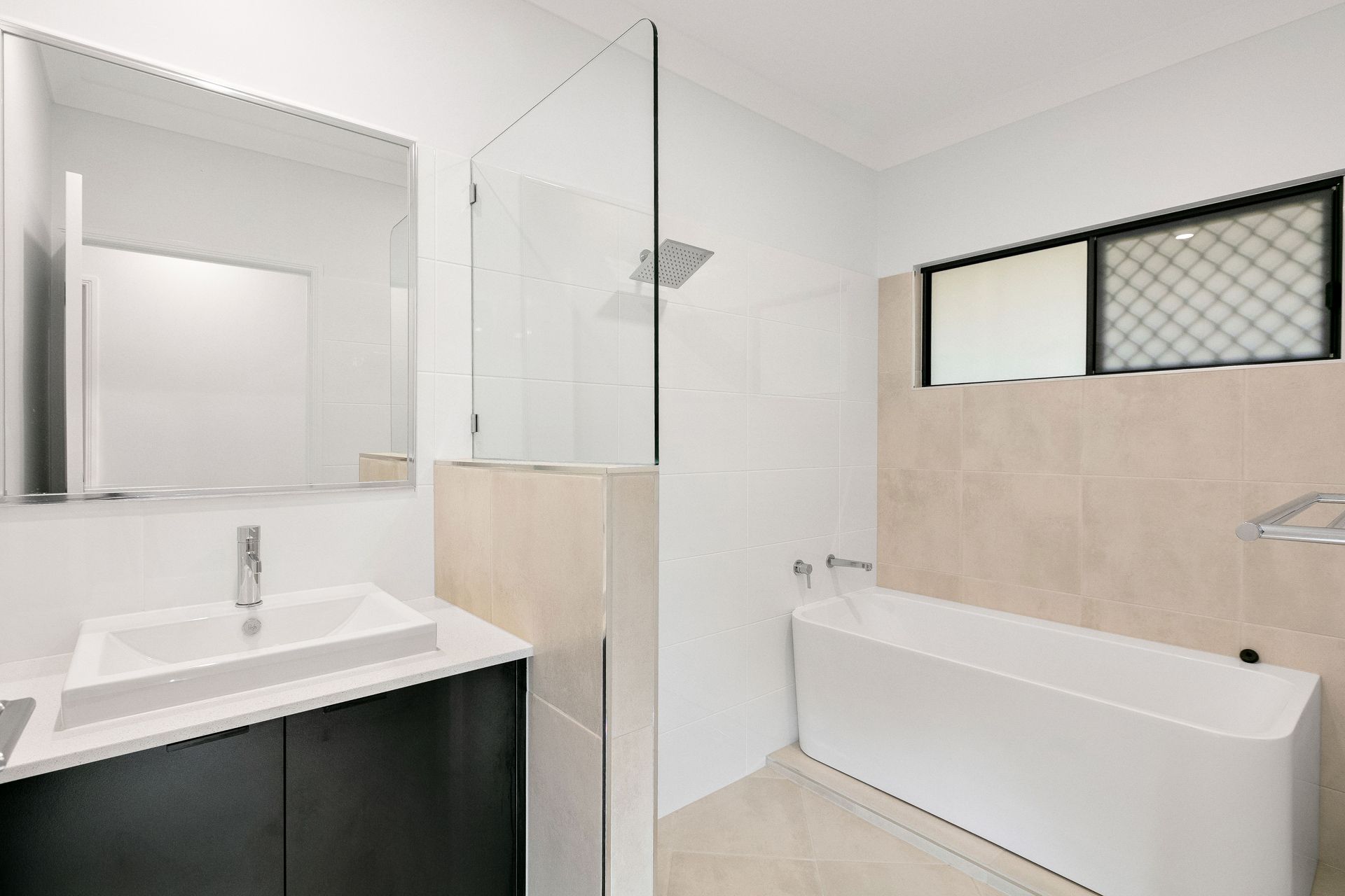 A Modern Bathroom Featuring a White Vanity With a Square Sink — Ashlee Jones Homes in Gordonvale, QLD