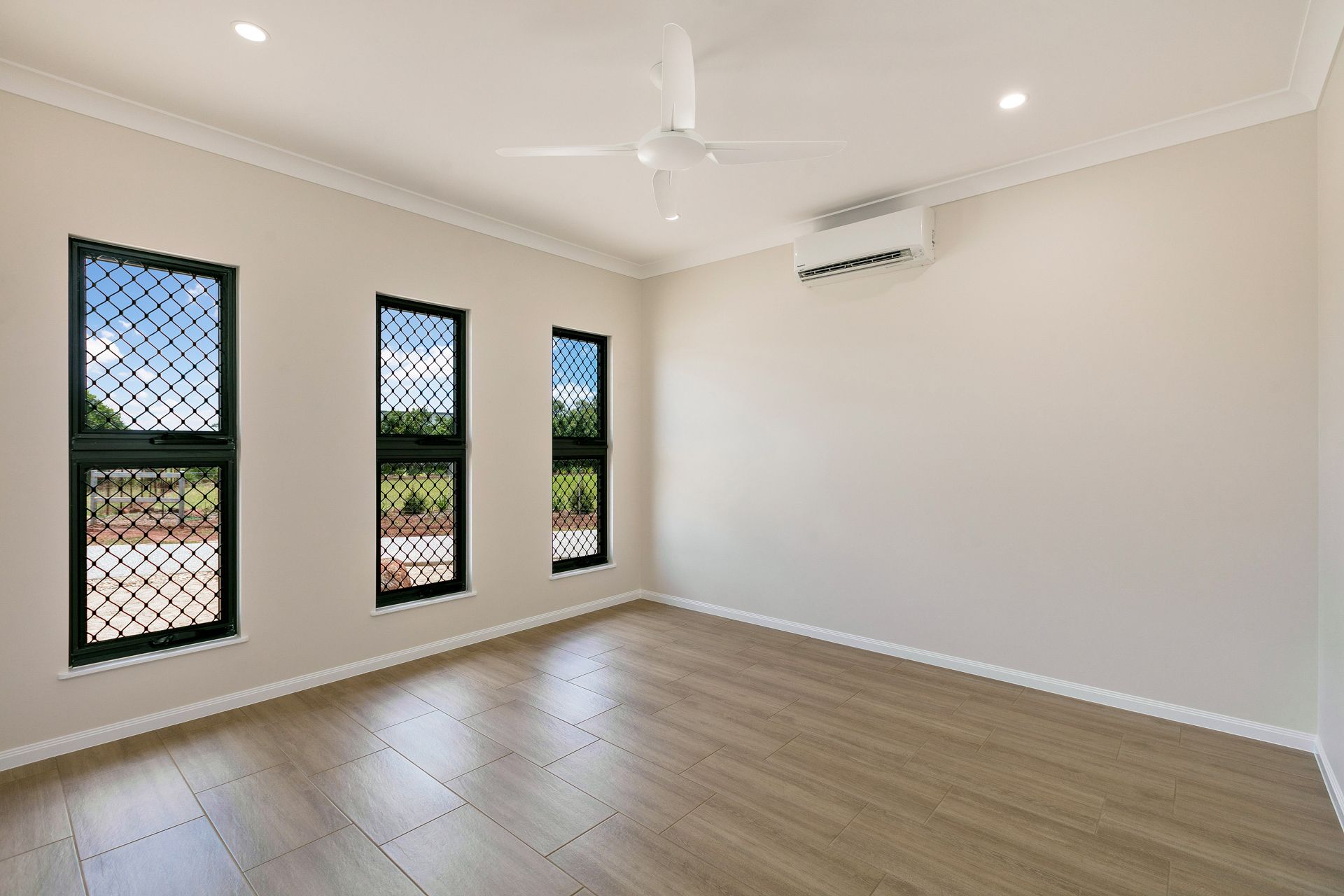An Empty Room With Light Wood-look Floors — Ashlee Jones Homes in Gordonvale, QLD