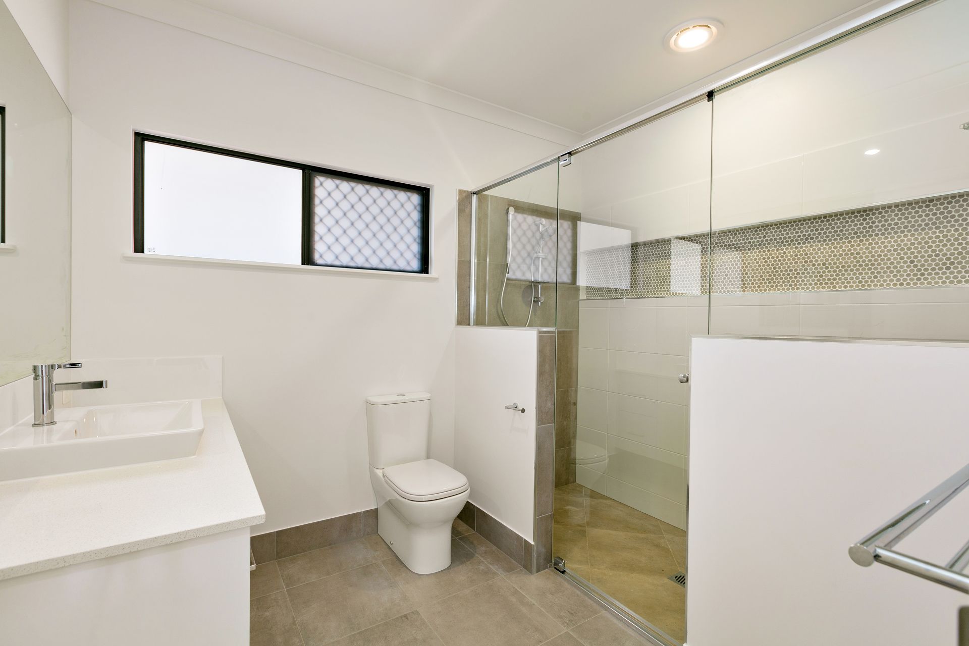 Modern Bathroom With a White Vanity, a Toilet — Ashlee Jones Homes in Gordonvale, QLD