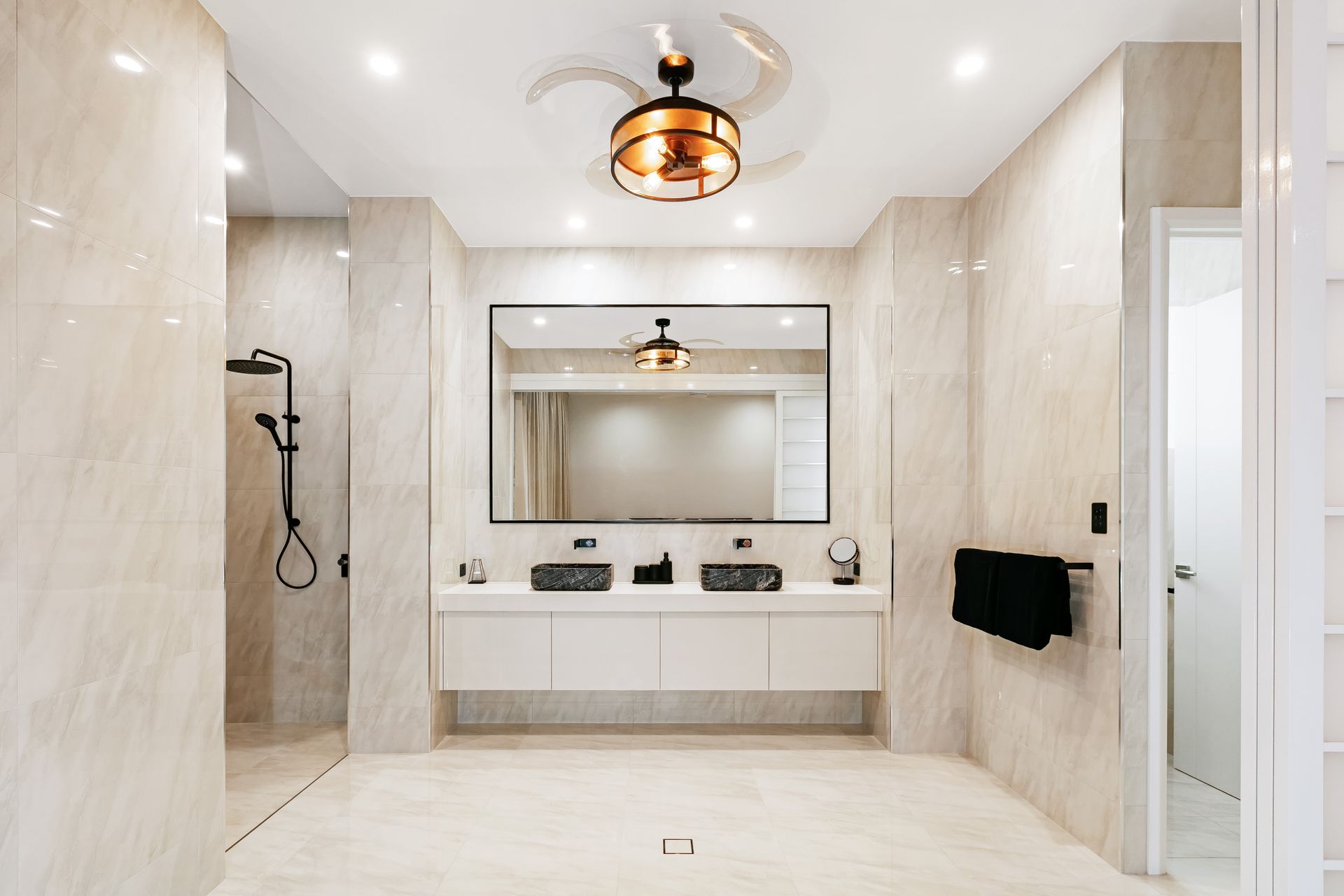 A Kitchen With A Large Island And Sliding Glass Doors — Ashlee Jones Homes in Gordonvale, QLD