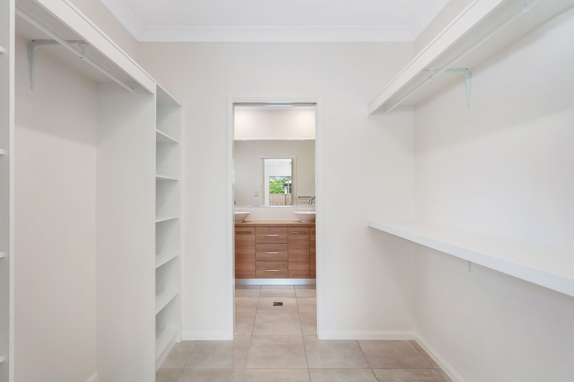 A Walk-in Closet With White Walls — Ashlee Jones Homes in Gordonvale, QLD