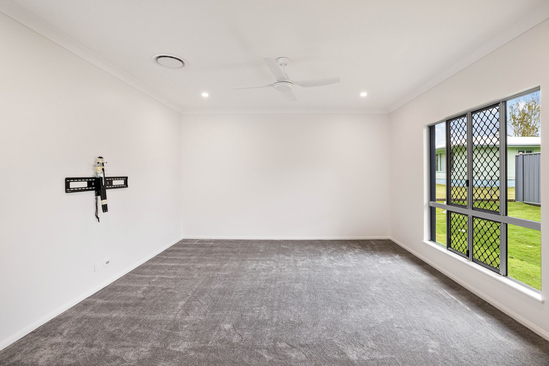 An Empty, Carpeted Room With White Walls — Ashlee Jones Homes in Gordonvale, QLD