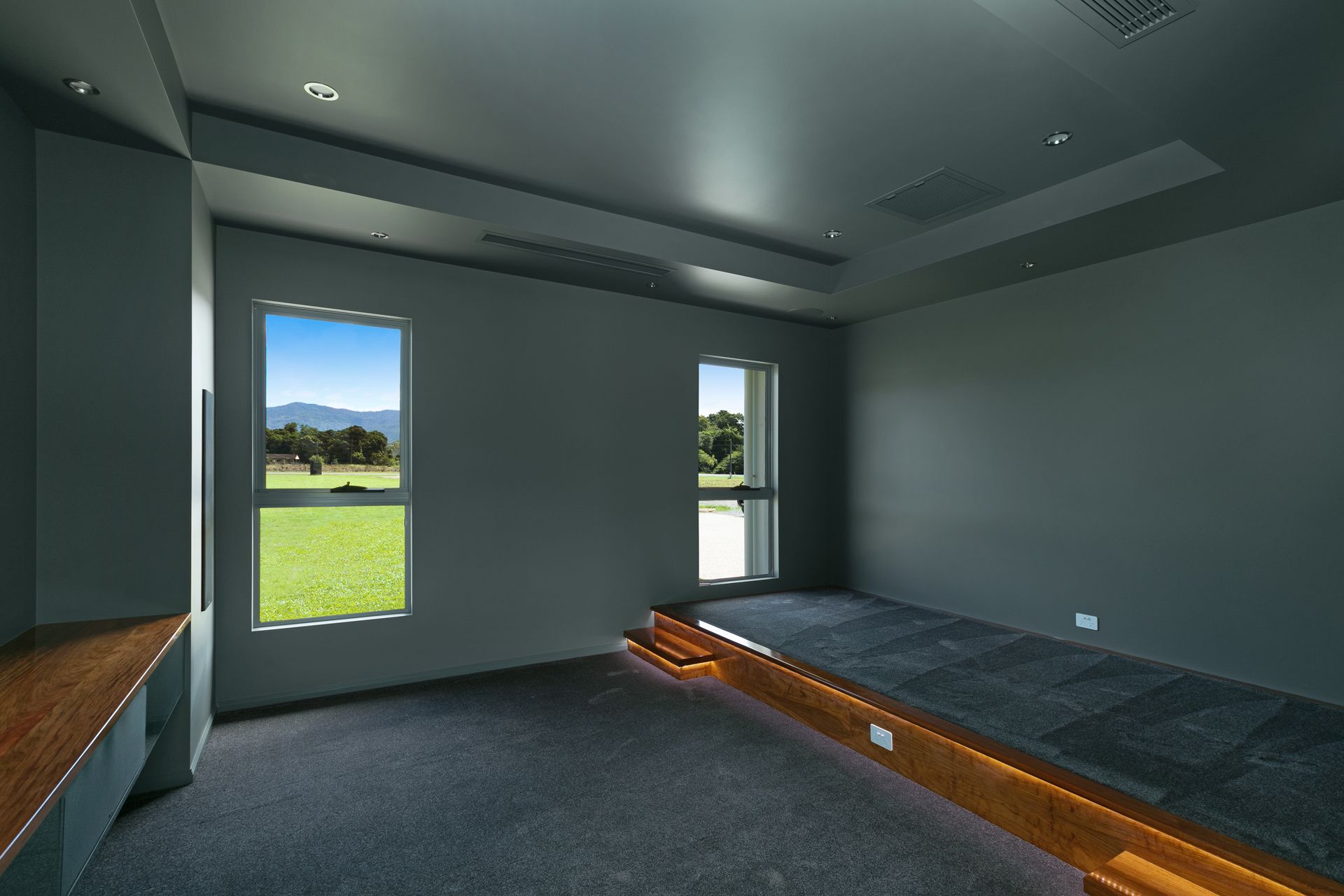 Modern Room With Dark Gray Walls, and a Carpeted Floors — Ashlee Jones Homes in Gordonvale, QLD