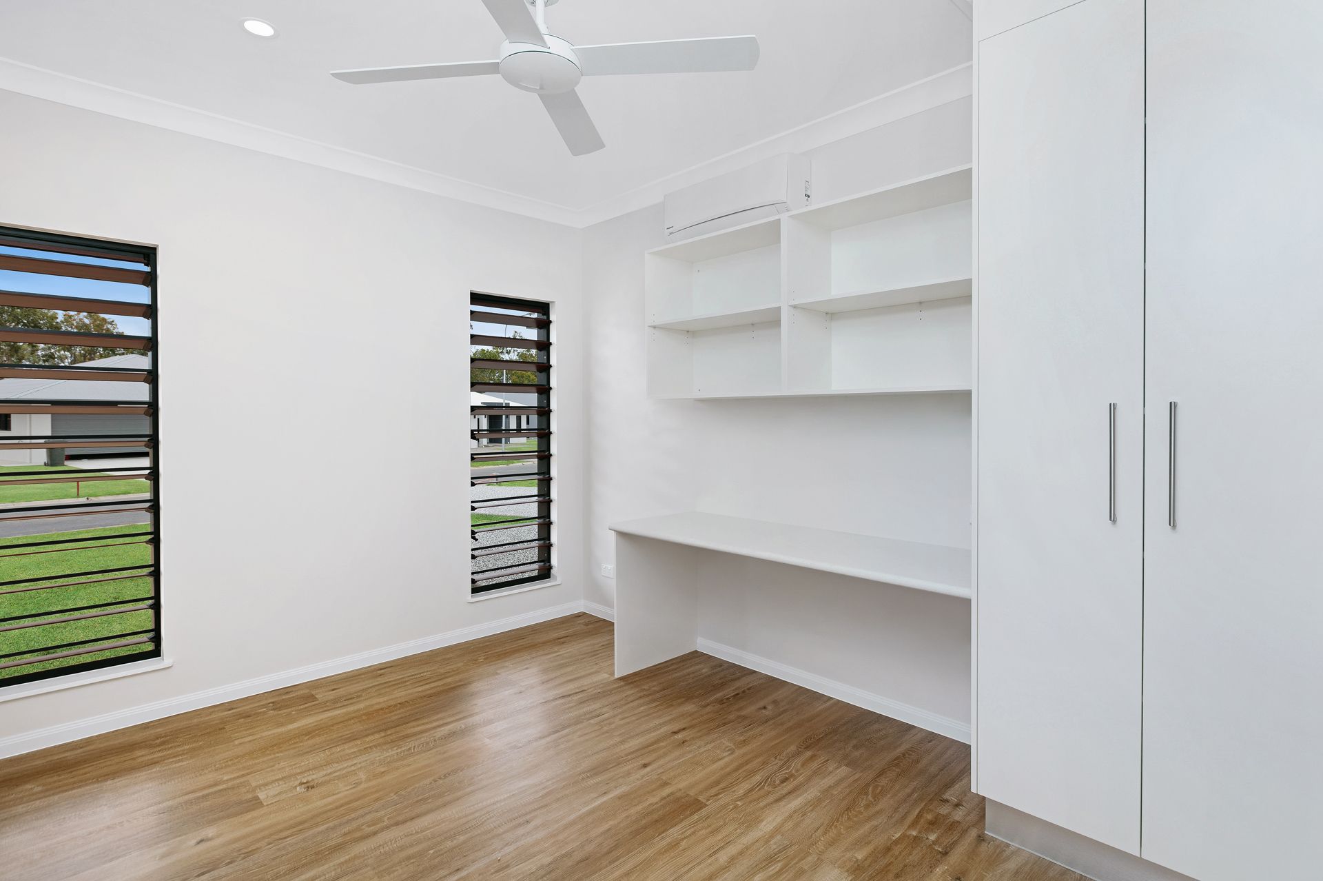 A Modern, Bright Room With White Walls, Wood-look Flooring — Ashlee Jones Homes in Gordonvale, QLD