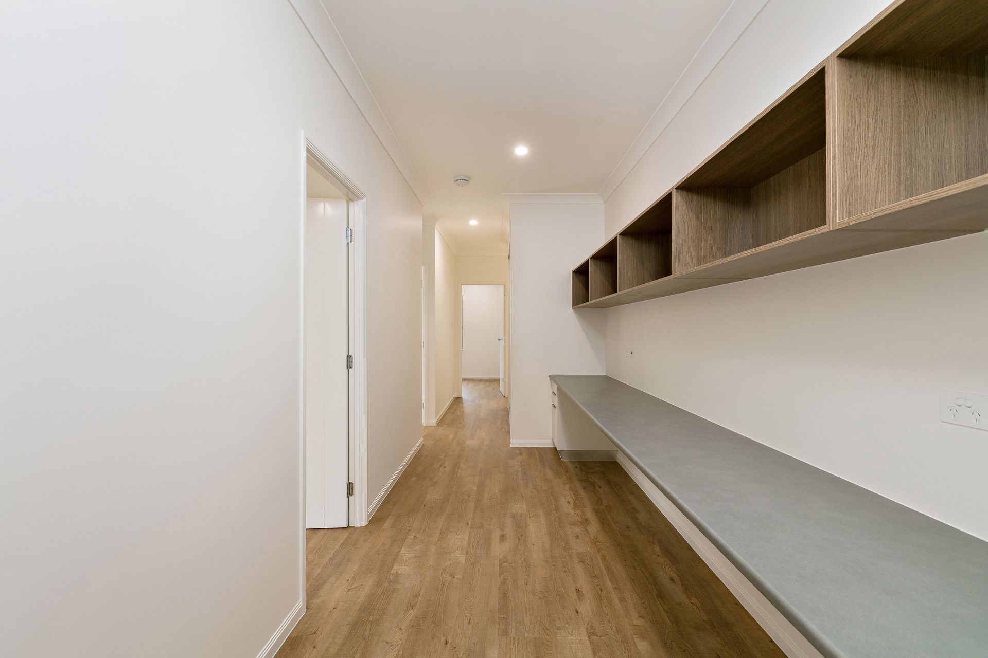 A Bright Hallway With Light Wood Flooring — Ashlee Jones Homes in Gordonvale, QLD