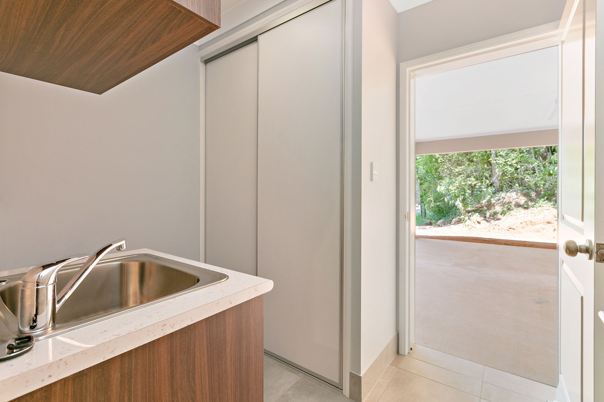 A Kitchen Sink With a Chrome Faucet Set in a Wooden Counter — Ashlee Jones Homes in Gordonvale, QLD