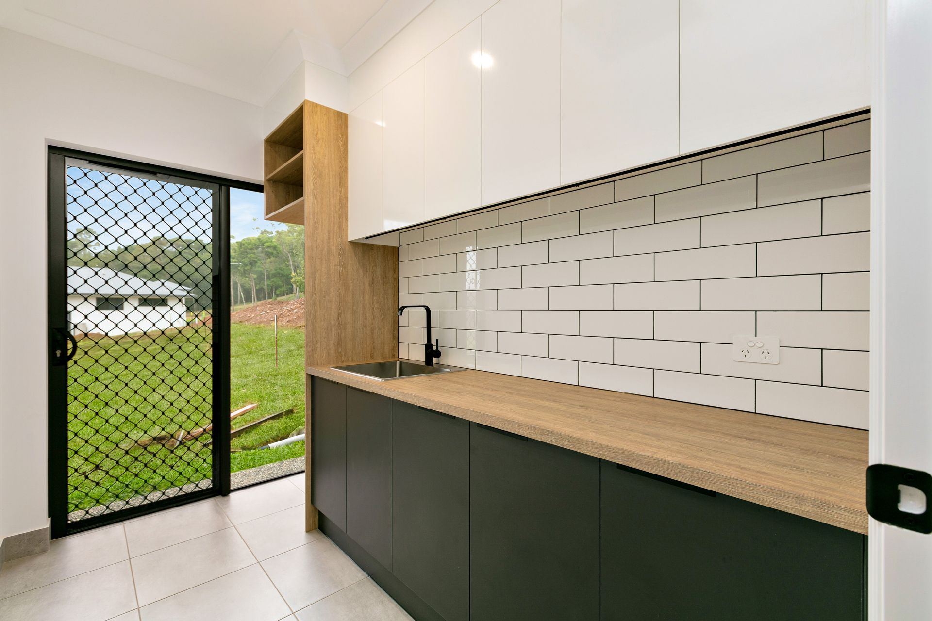 Modern Kitchenette With White Upper Cabinets — Ashlee Jones Homes in Gordonvale, QLD