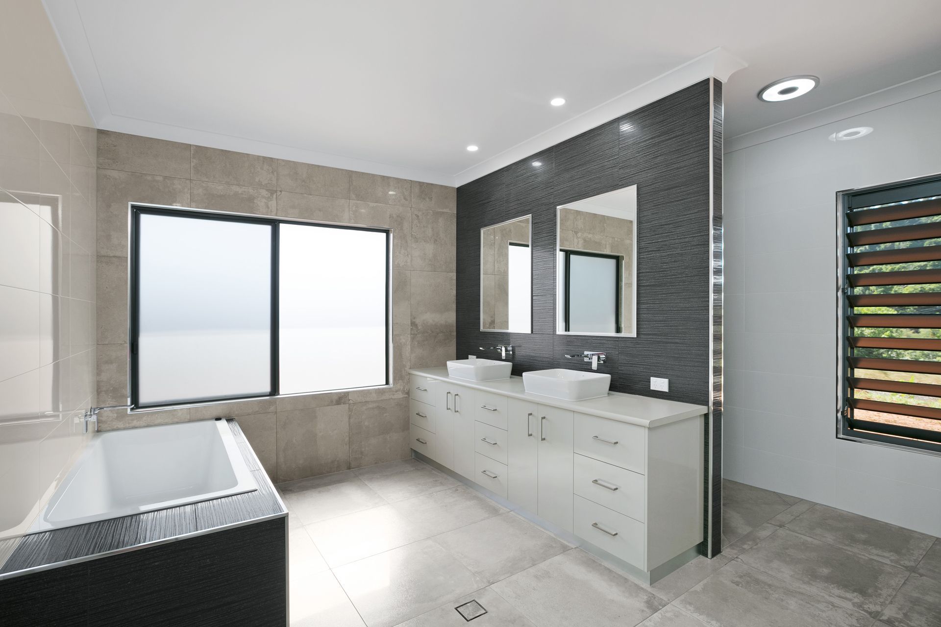 A Modern Bathroom Featuring a White Bathtub — Ashlee Jones Homes in Gordonvale, QLD