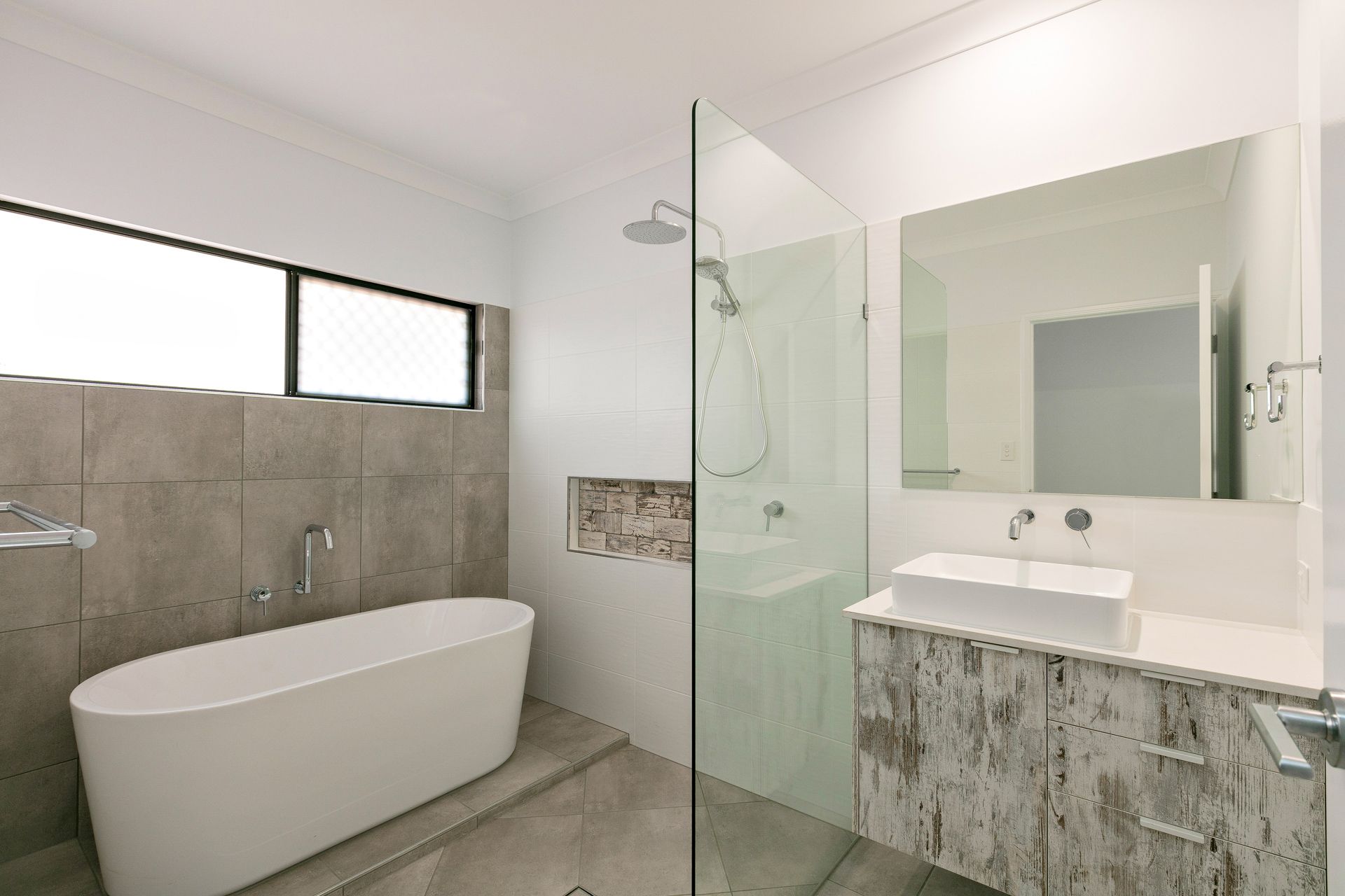 Modern Bathroom With a Freestanding White Tub — Ashlee Jones Homes in Gordonvale, QLD
