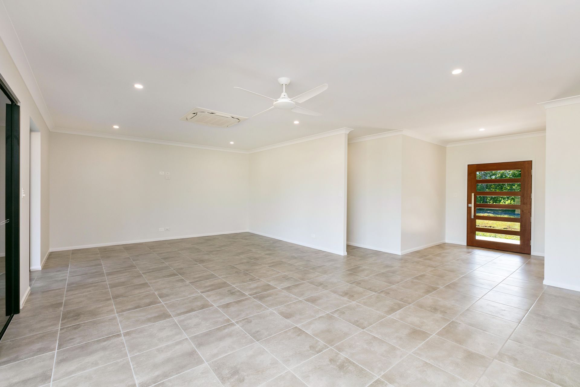 A Spacious, Empty Interior Room With Neutral Walls — Ashlee Jones Homes in Gordonvale, QLD