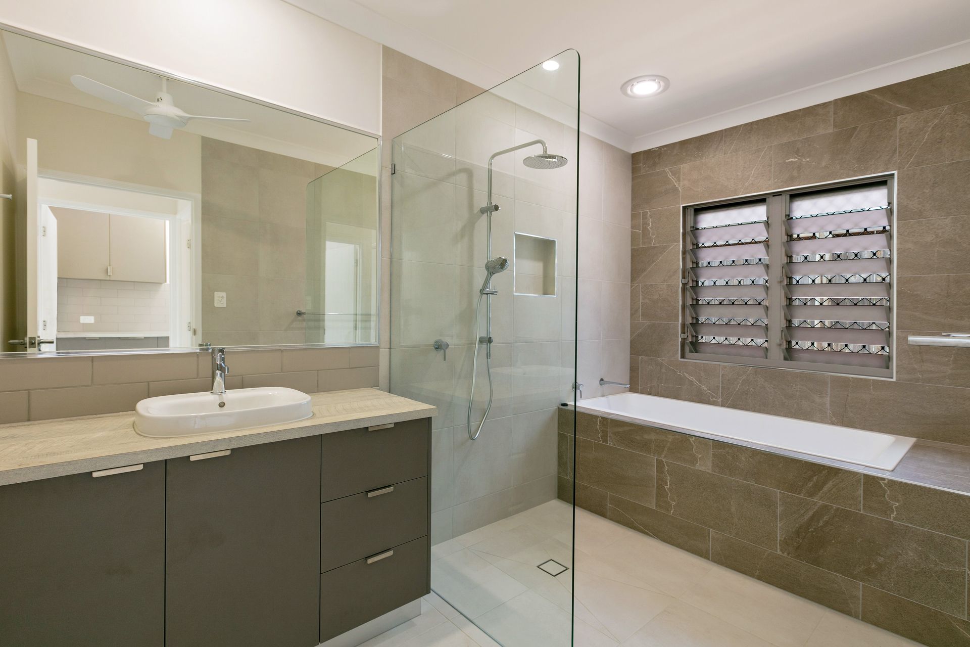 Modern Bathroom With a Gray Vanity, Rectangular Sink — Ashlee Jones Homes in Gordonvale, QLD