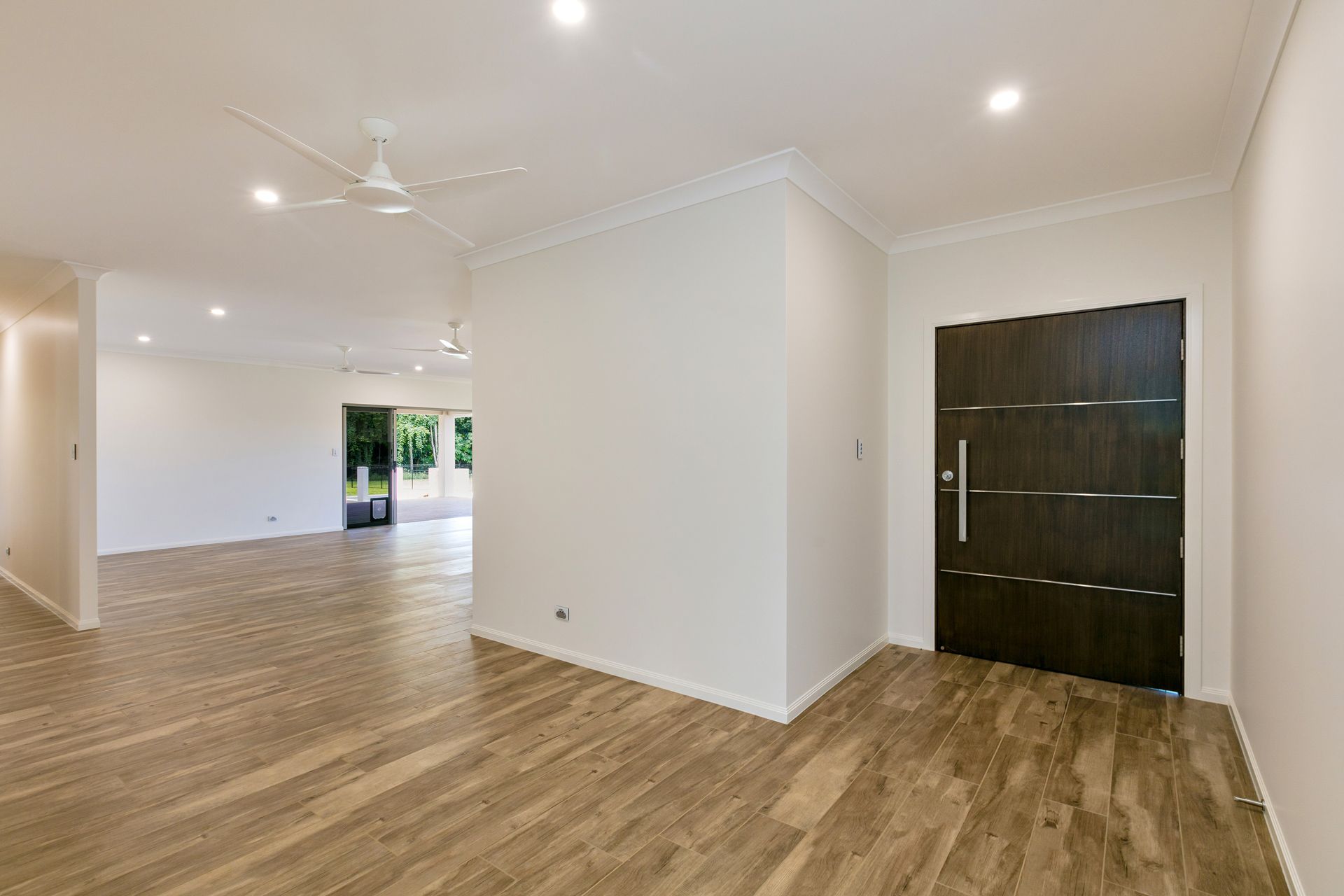 A Spacious, Modern Interior With Light Wood-look Flooring — Ashlee Jones Homes in Gordonvale, QLD