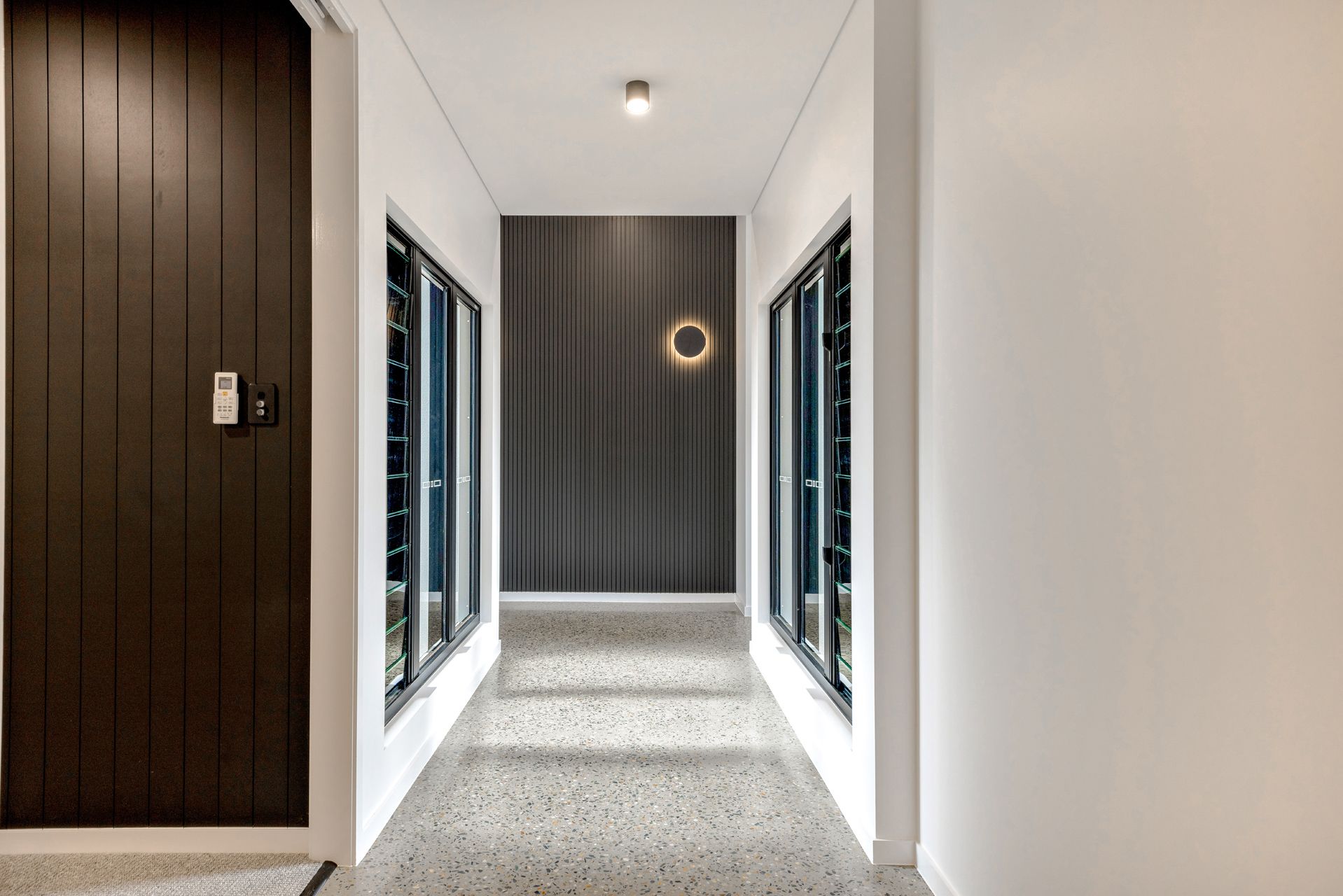 A Hallway With Terrazzo Floors, White Walls — Ashlee Jones Homes in Gordonvale, QLD