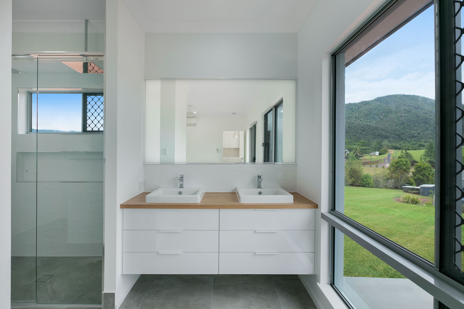 A Modern Bathroom With a Double White Vanity — Ashlee Jones Homes in Gordonvale, QLD