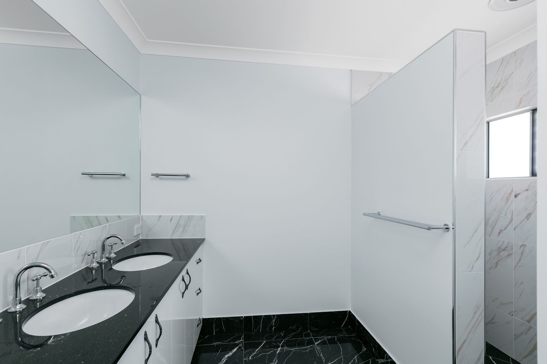 A Modern Bathroom With a Black Stone Vanity — Ashlee Jones Homes in Gordonvale, QLD