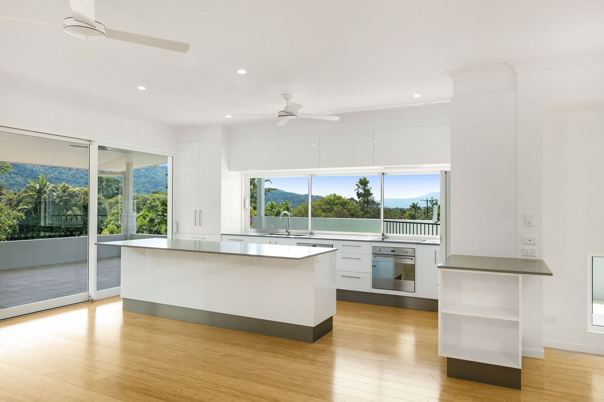 A Minimalist, Modern Kitchen With a White Island — Ashlee Jones Homes in Gordonvale, QLD