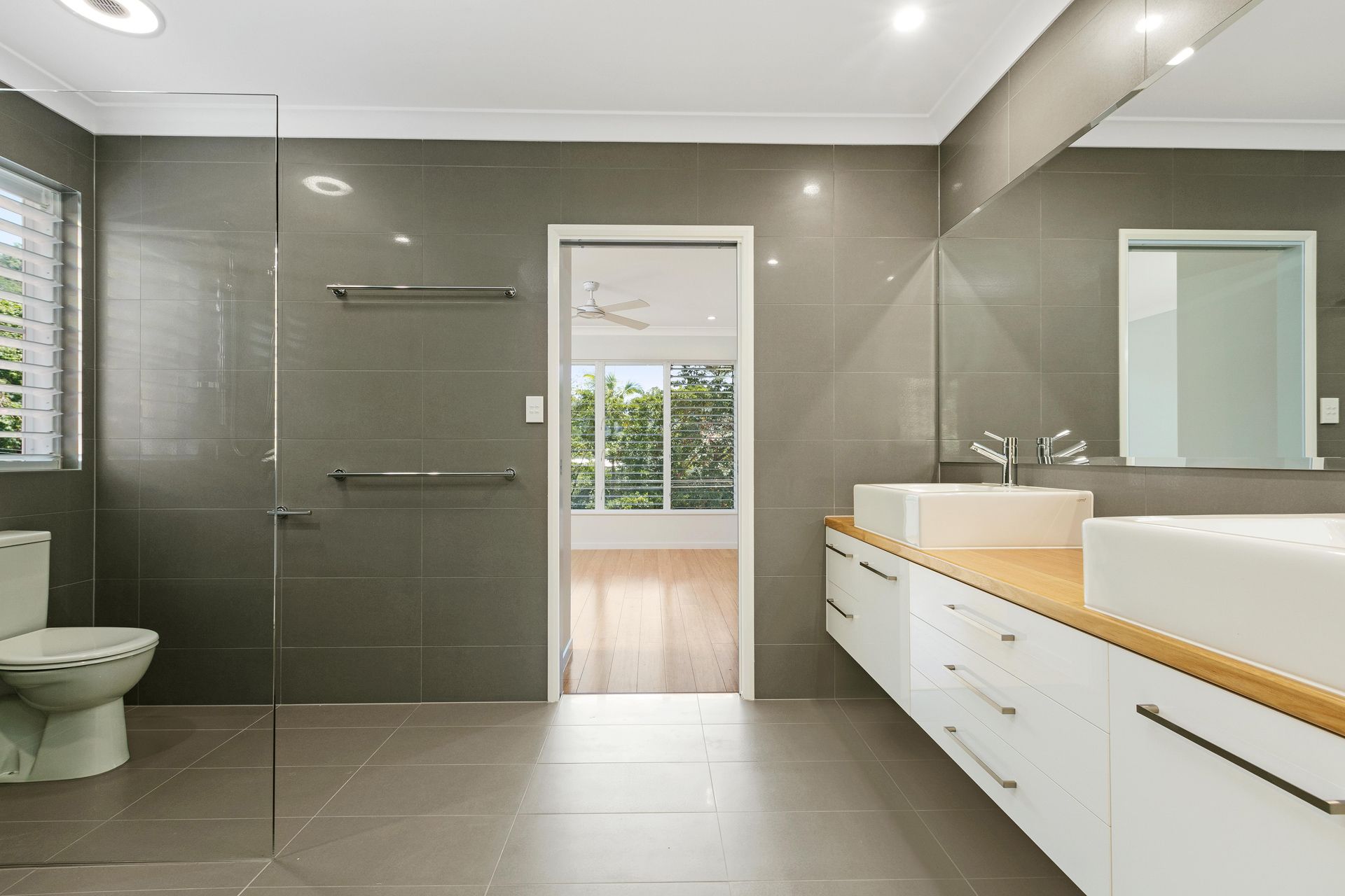 Modern Bathroom Featuring Gray Tiled Walls — Ashlee Jones Homes in Gordonvale, QLD