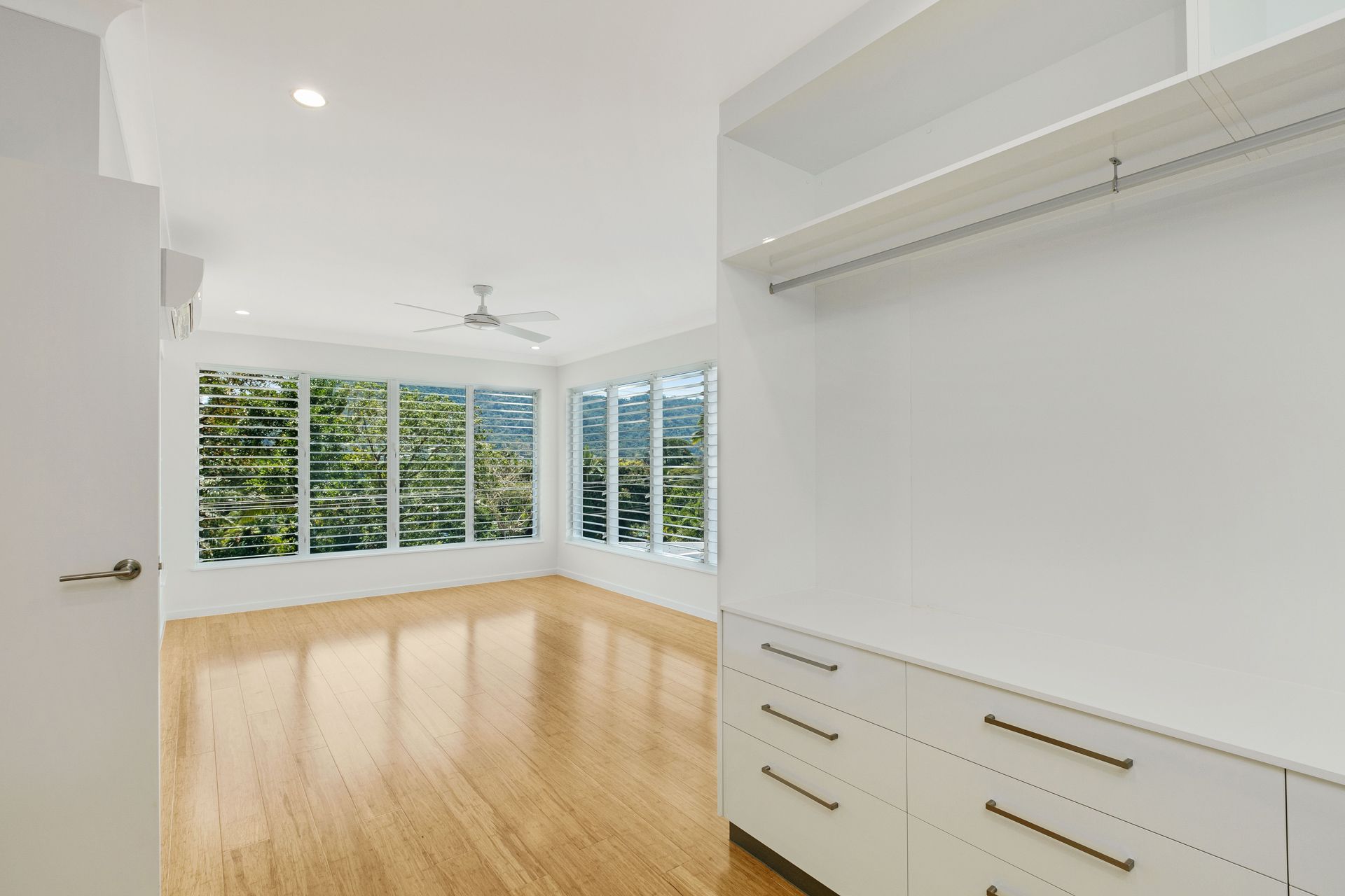Bright, Empty Room With Light Hardwood Floors — Ashlee Jones Homes in Gordonvale, QLD