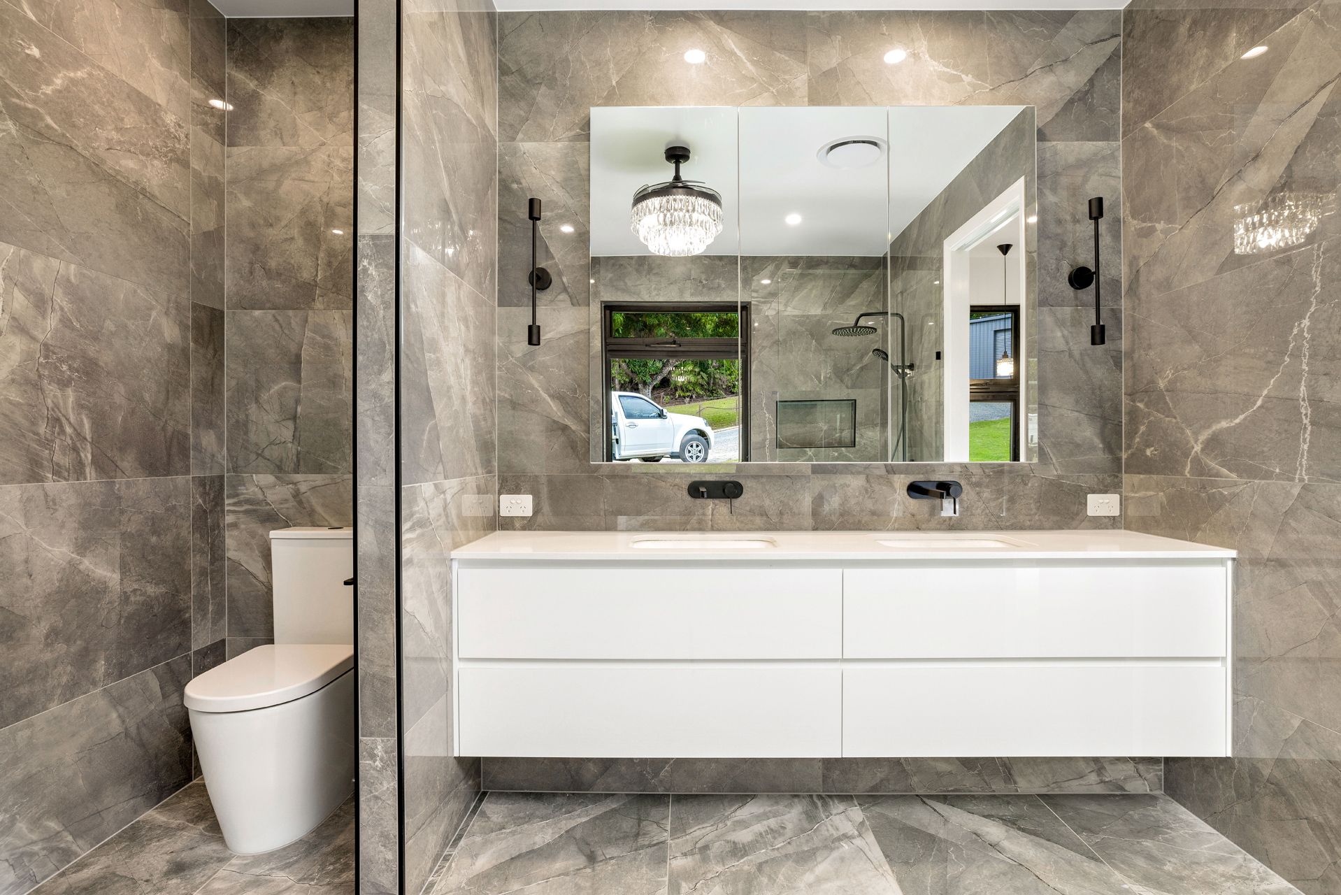 A Modern Bathroom Featuring Grey Marble-tiled Walls — Ashlee Jones Homes in Gordonvale, QLD