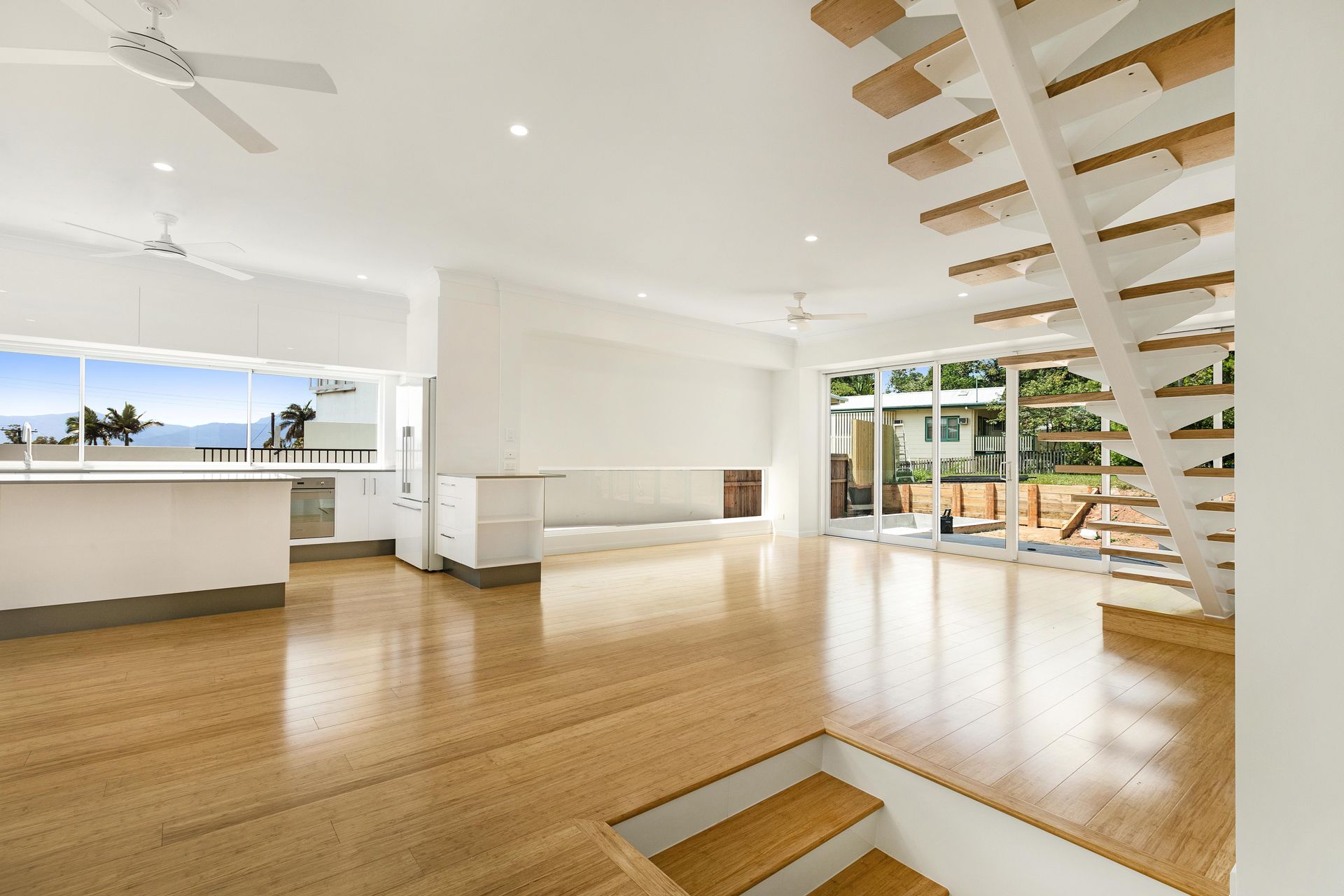 A Spacious, Modern Open-plan Room With White Walls — Ashlee Jones Homes in Gordonvale, QLD