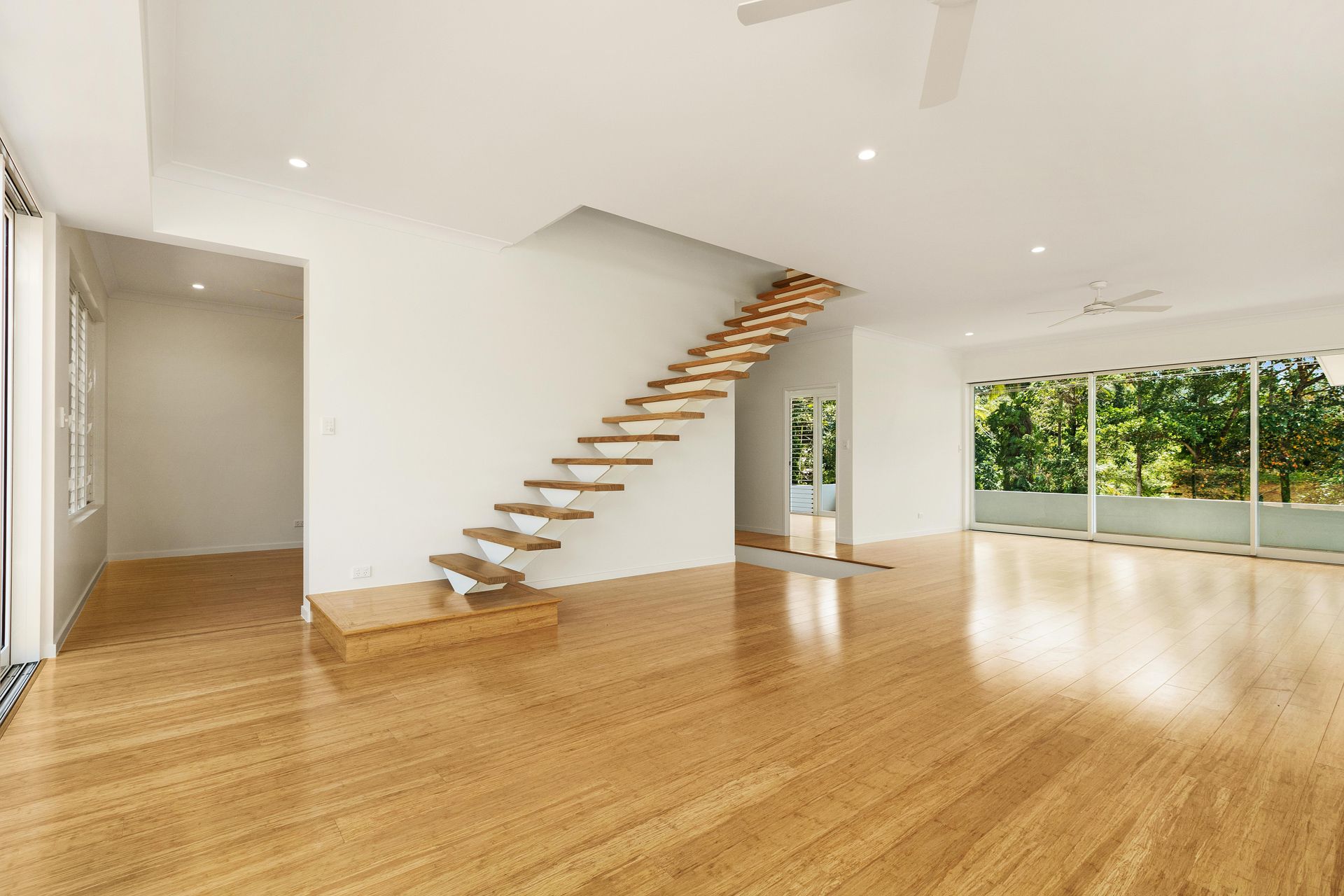 Bright, Spacious Interior With Light Wood Flooring, White Walls — Ashlee Jones Homes in Gordonvale, QLD