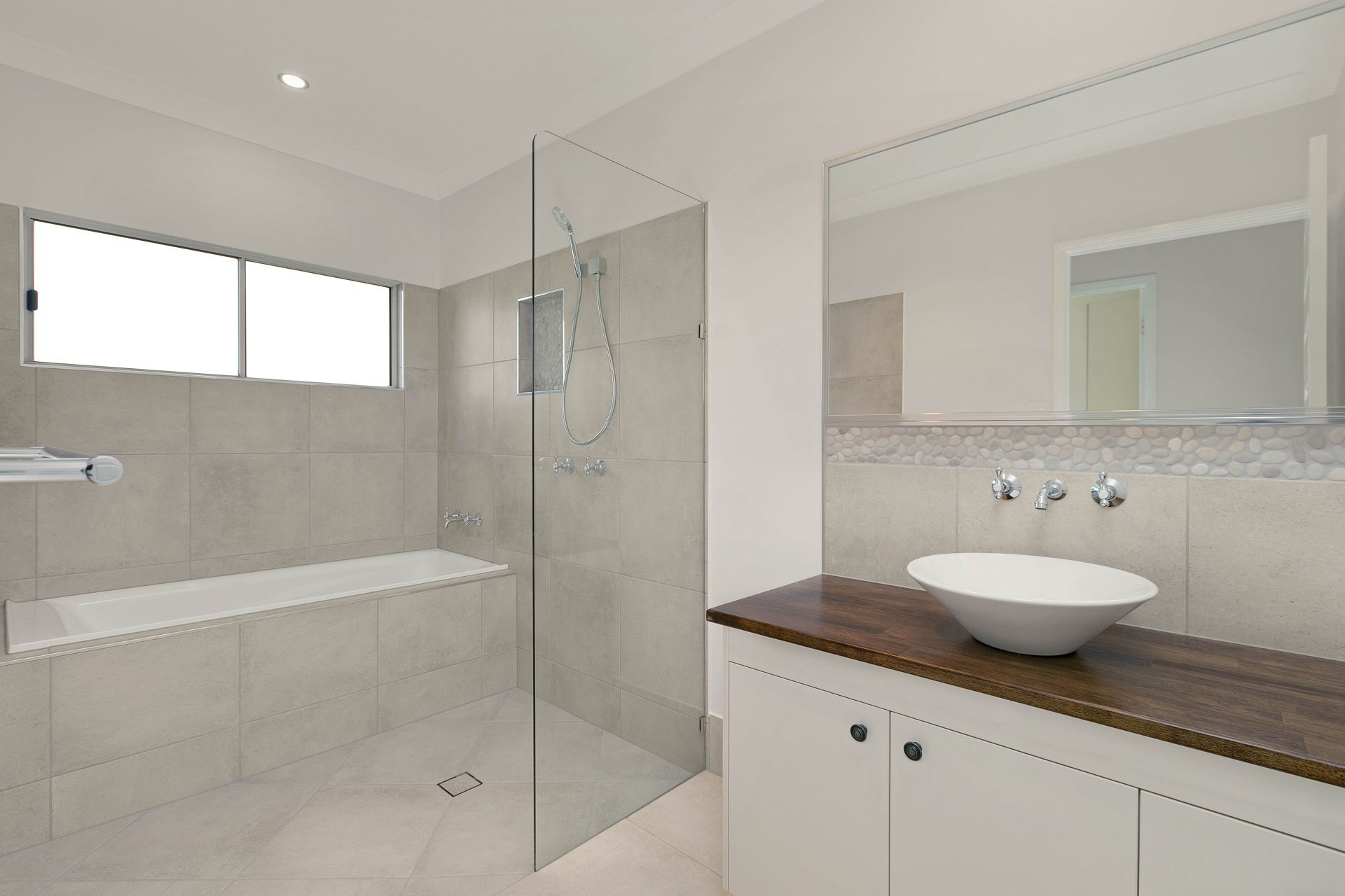 Modern Bathroom With a White Vessel Sink on a Wood Vanity — Ashlee Jones Homes in Gordonvale, QLD