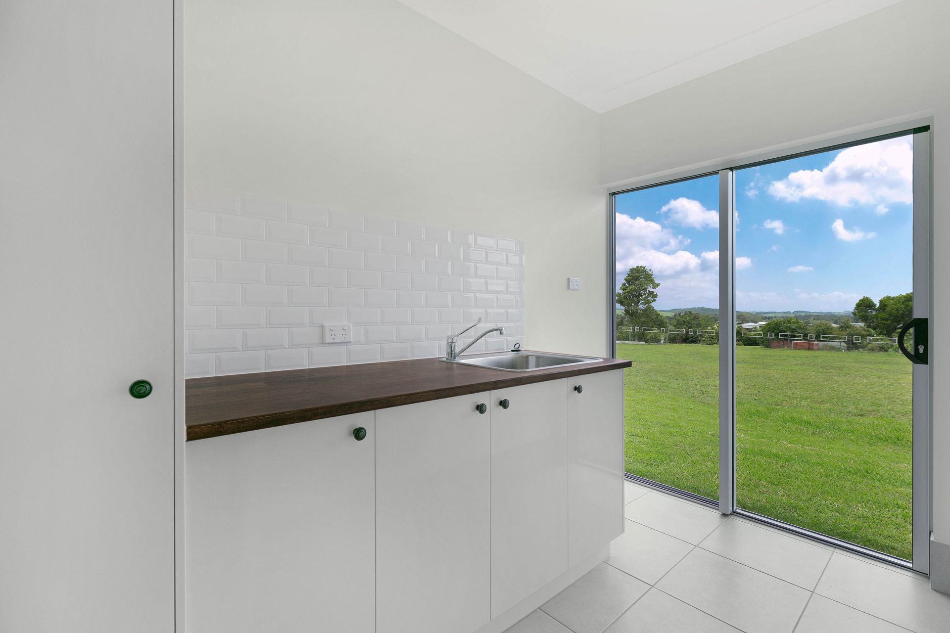 White Kitchen Counter With Sink, Subway Tile Backsplash — Ashlee Jones Homes in Gordonvale, QLD