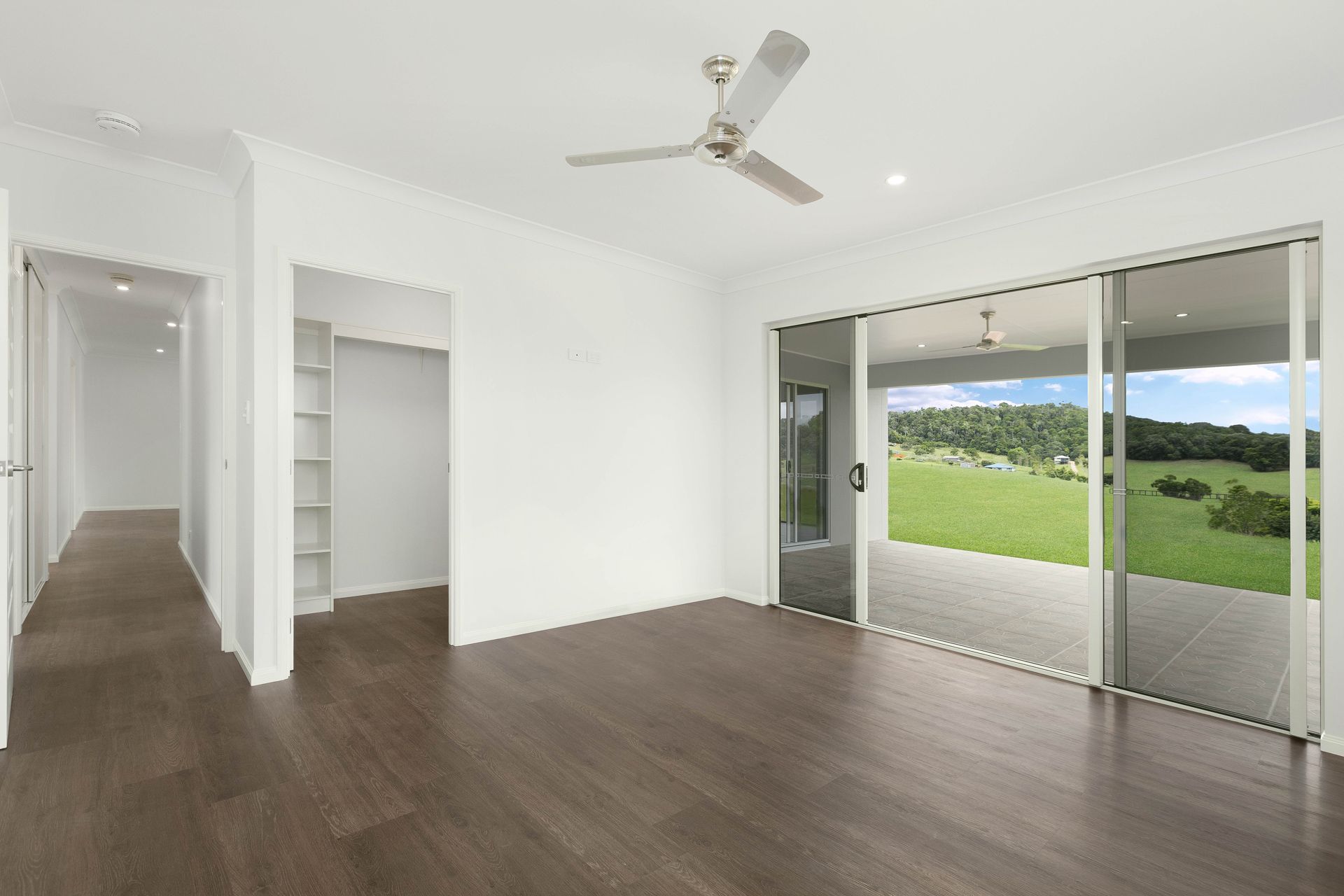 An Unfurnished Room With Dark Wood Flooring — Ashlee Jones Homes in Gordonvale, QLD