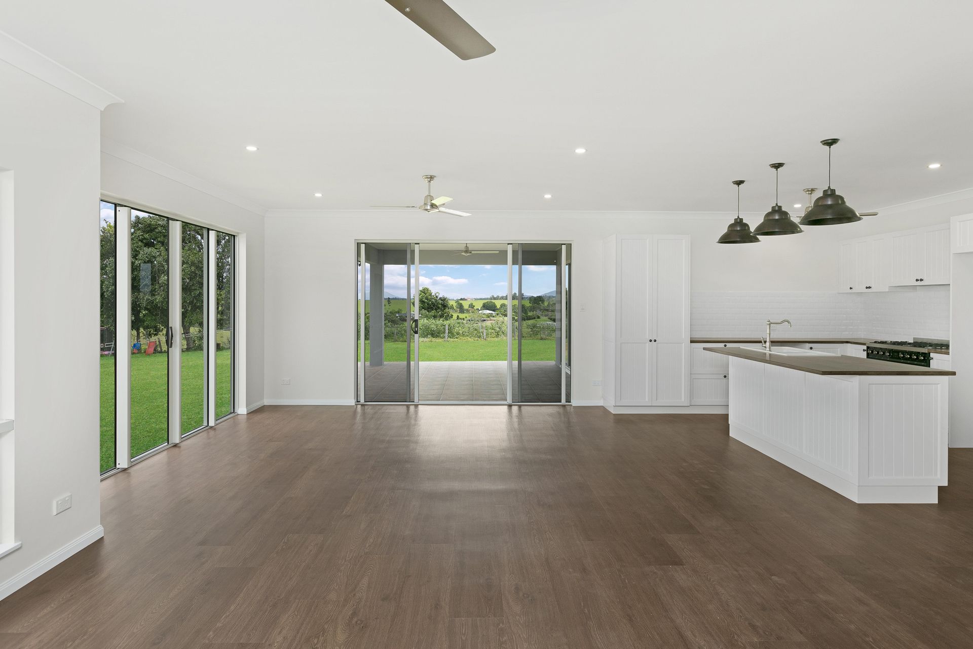 A Bright, Open-plan Living Area With White Walls — Ashlee Jones Homes in Gordonvale, QLD