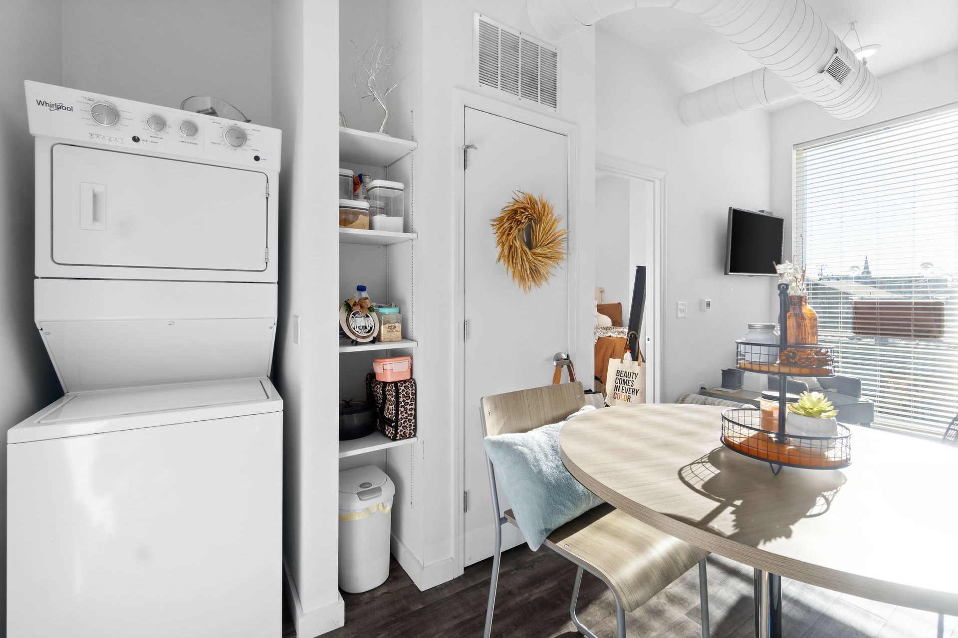 Photo showing a dining area next to washer/dryer area