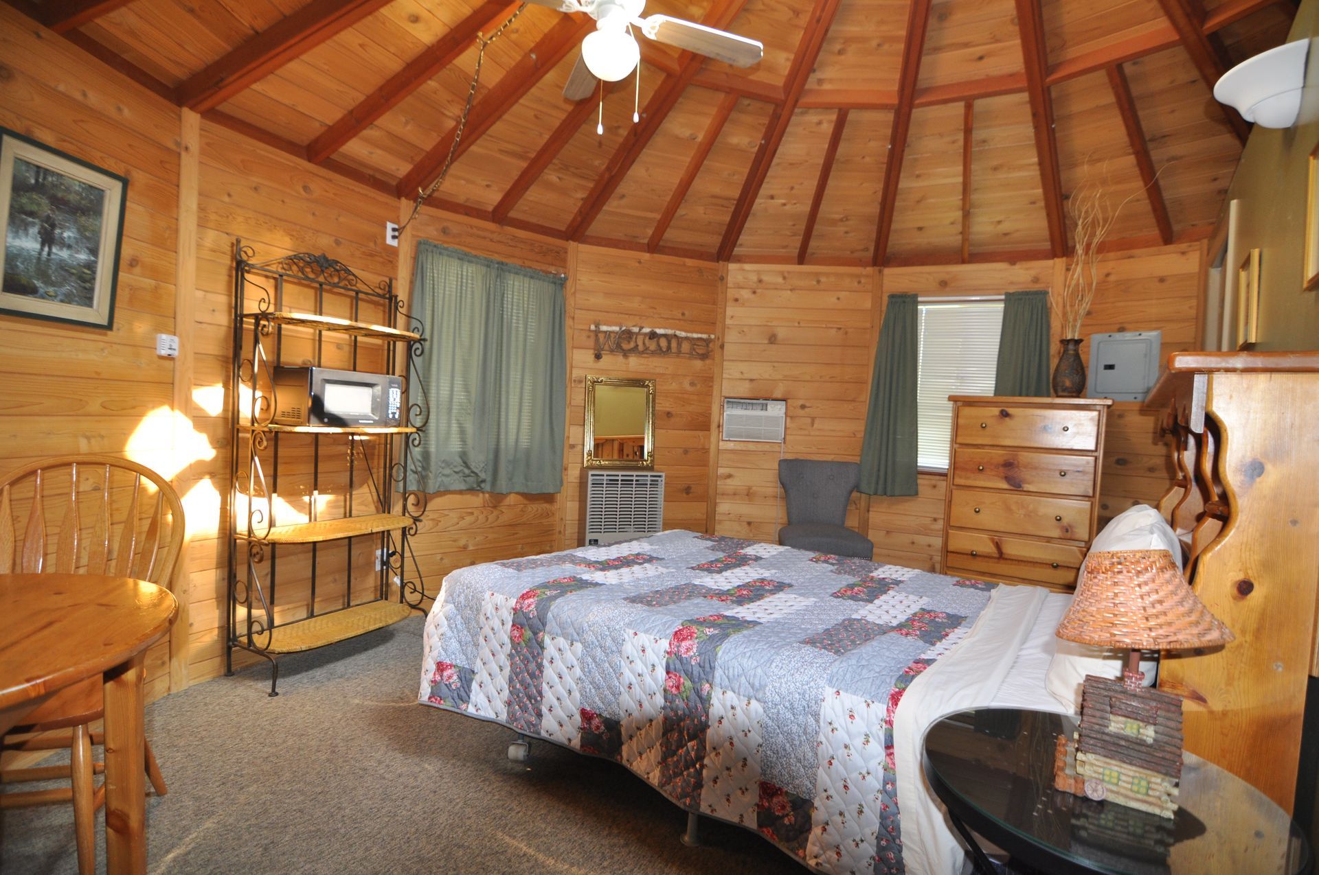 A bedroom with a king size bed and a ceiling fan
